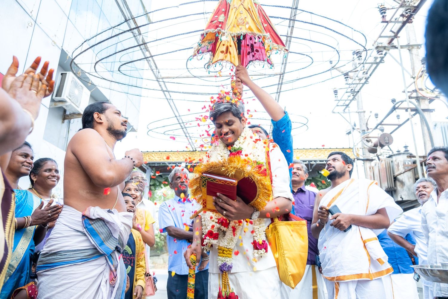 A lively South Indian temple ceremony with priests and devotees in traditional dress.
