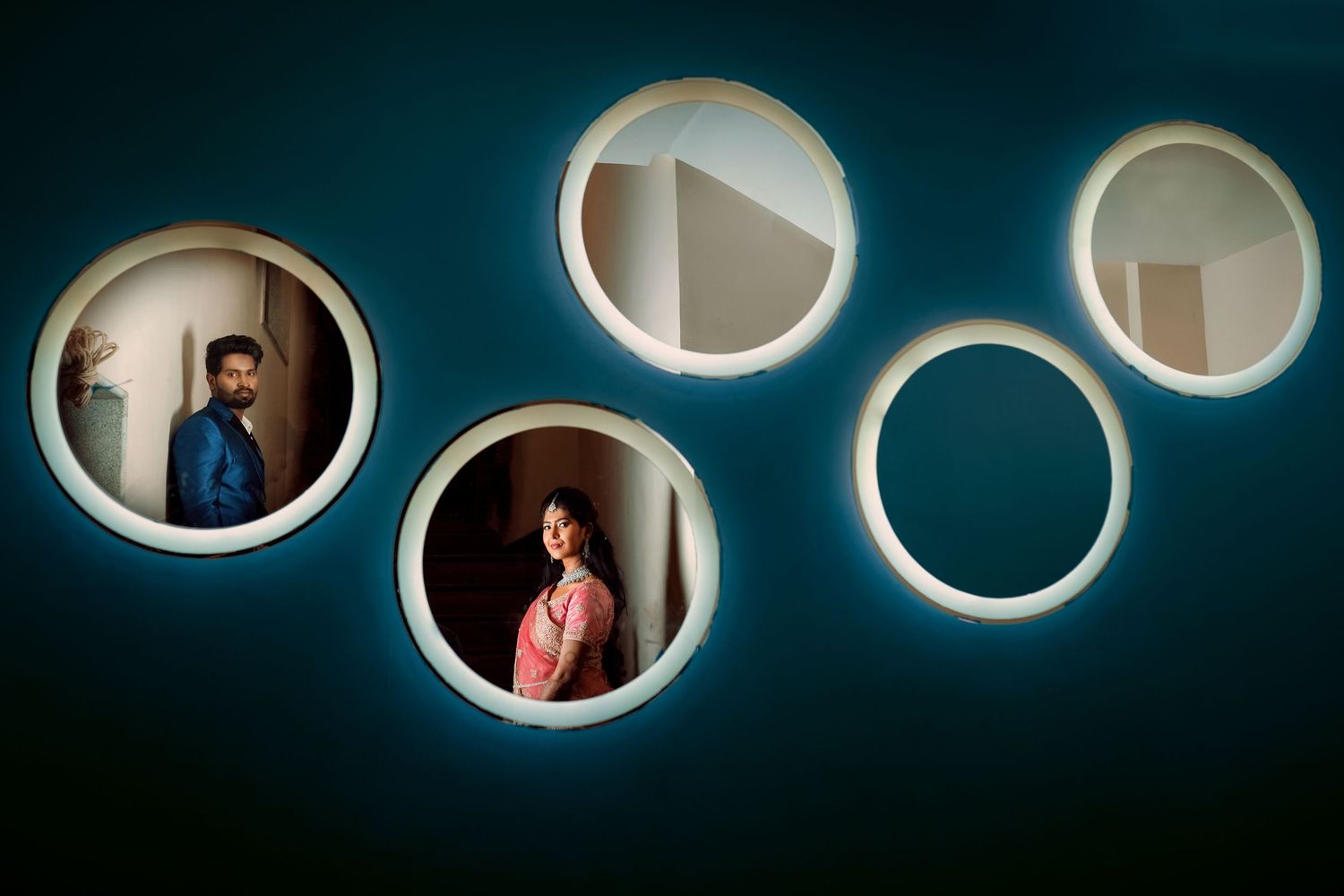 Modern interior design featuring five circular porthole-style windows with dramatic lighting.