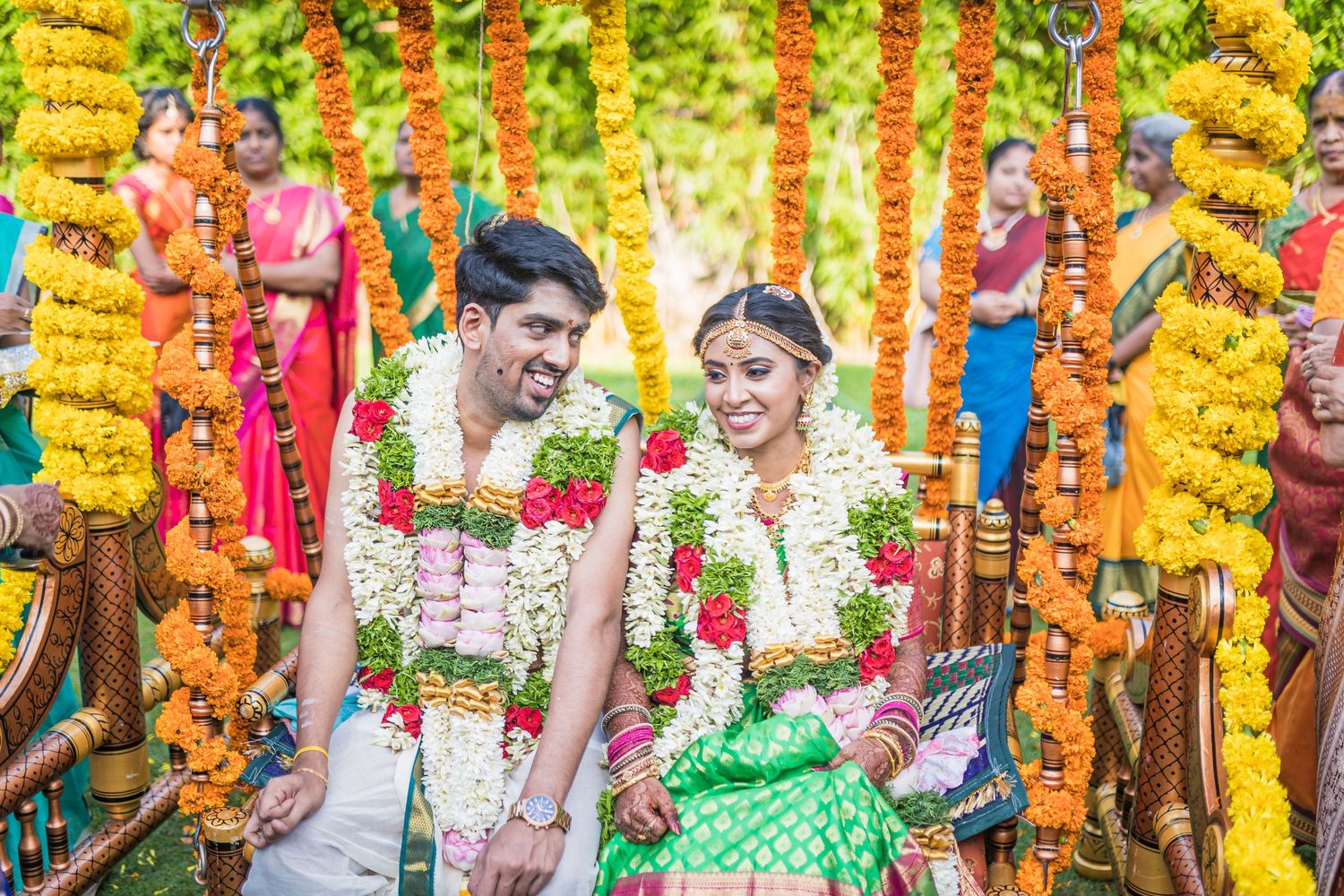 Colorful South Indian wedding ceremony with marigold garlands and festive decorations.