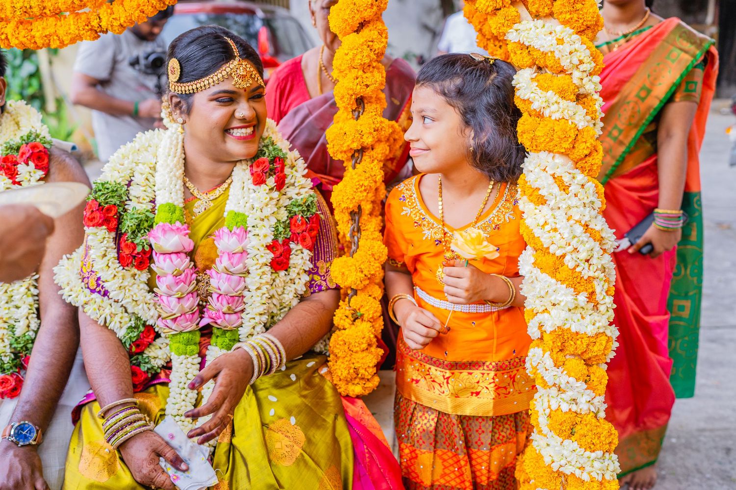 Traditional South Indian wedding ceremony with colorful floral garlands and decorative elements.