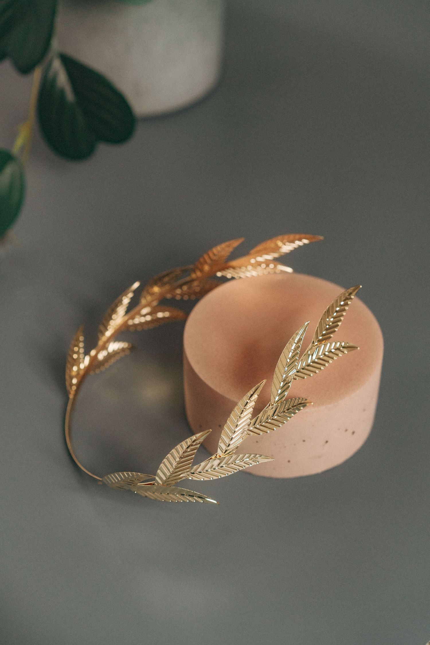 Gold plated head band on top of a stone prop.