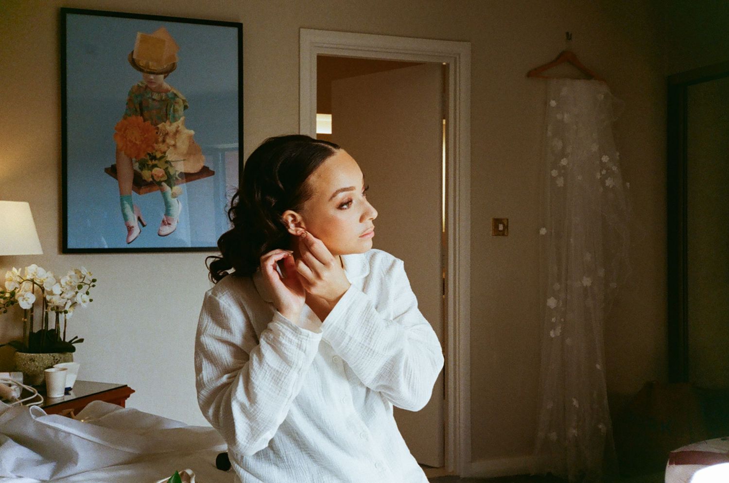 Analogue photo of bride getting ready adjusting her earring