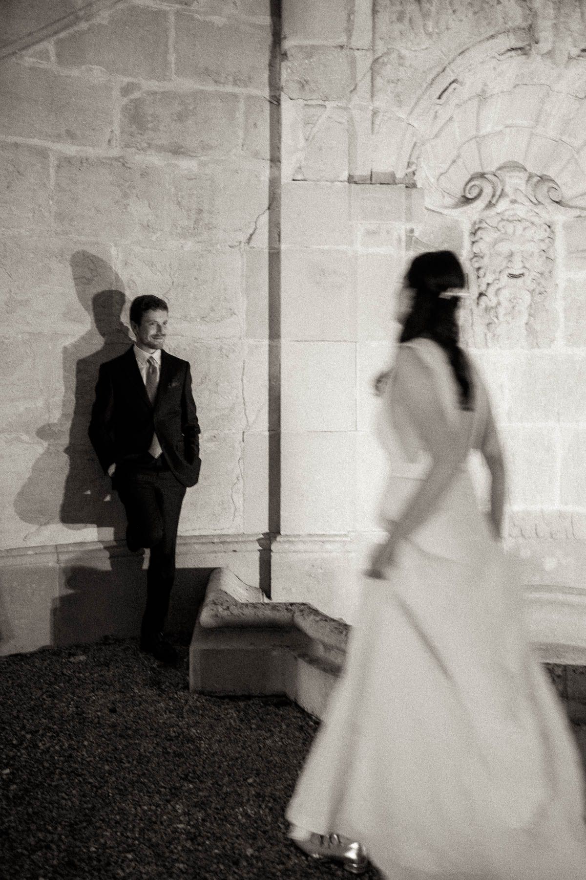 A series of black and white wedding photos showing silhouettes of a couple against a stone wall in an artistic sequence.