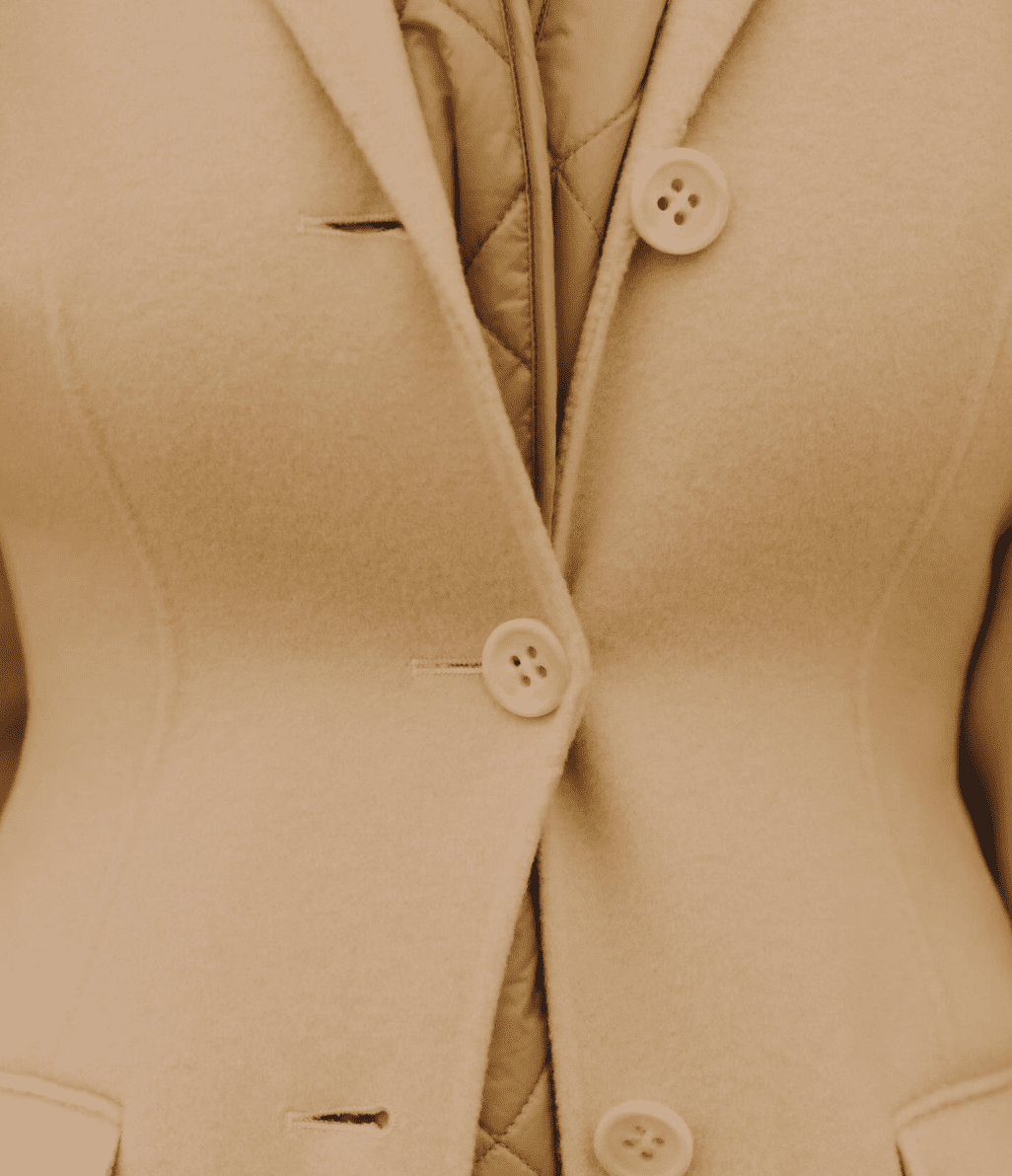Close-up view of tan colored suit jacket buttons and lapel showing fine tailoring details and stitching.