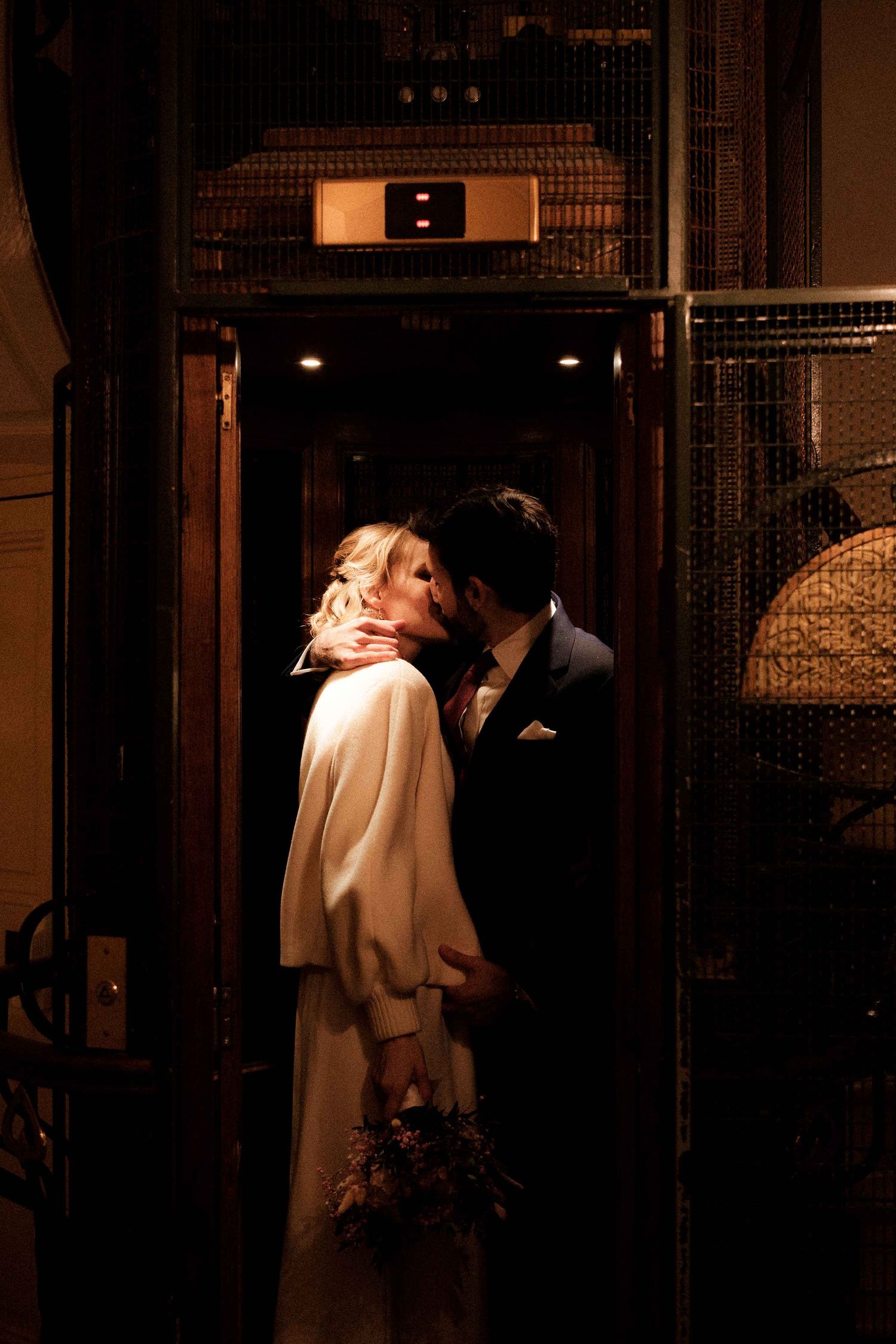 Dramatic noir-style sequence showing two figures in an intimate moment in a dimly lit doorway.