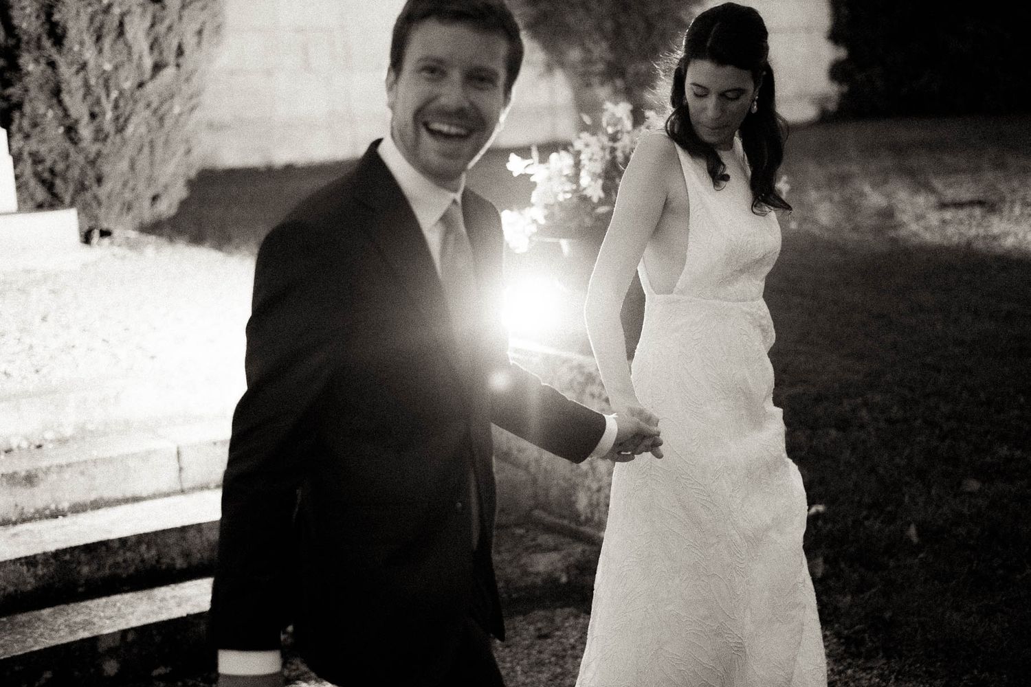 Black and white wedding photo collage showing romantic moments between newlyweds during their outdoor celebration.