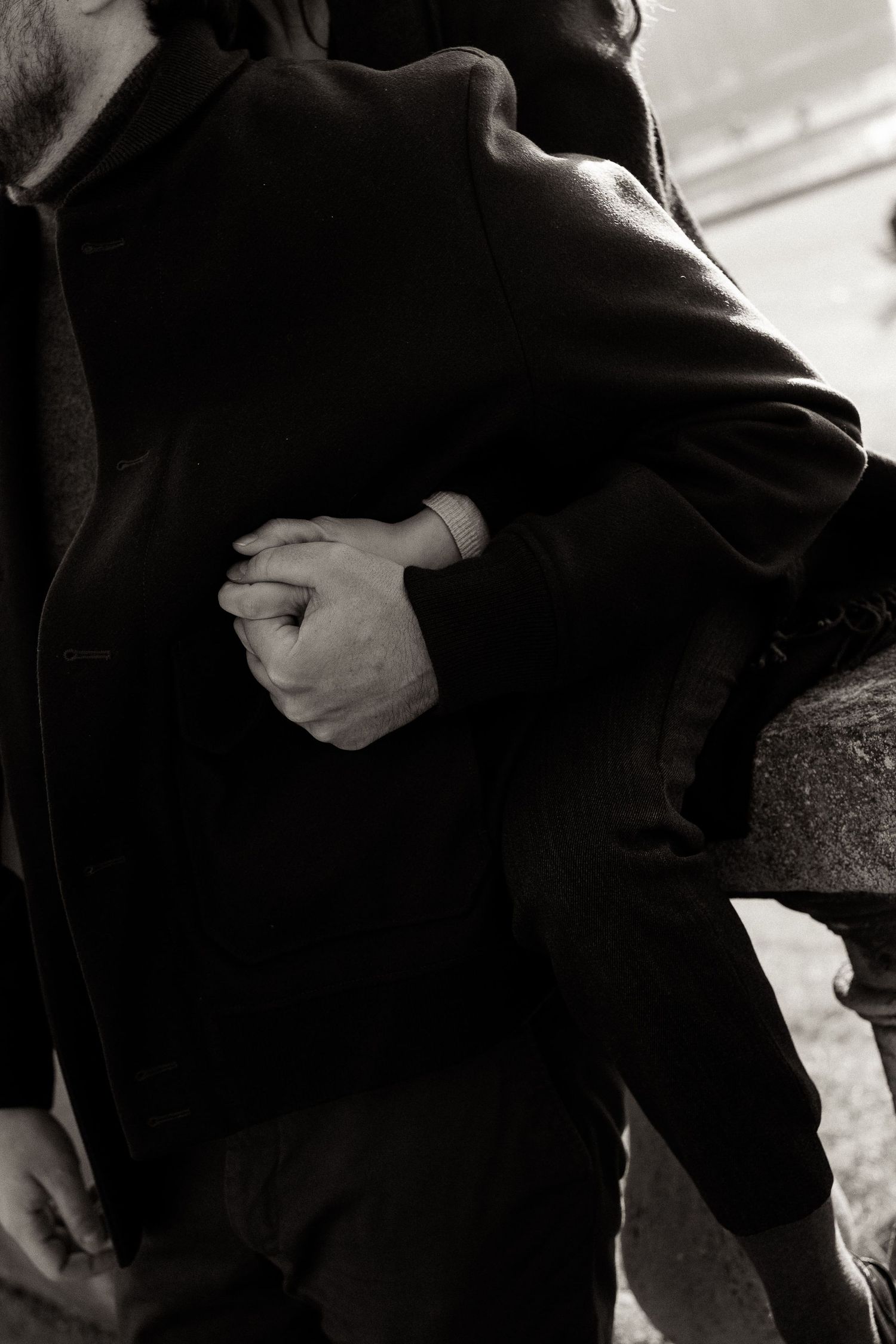 A series of black and white images showing close-up details of people embracing in formal attire.