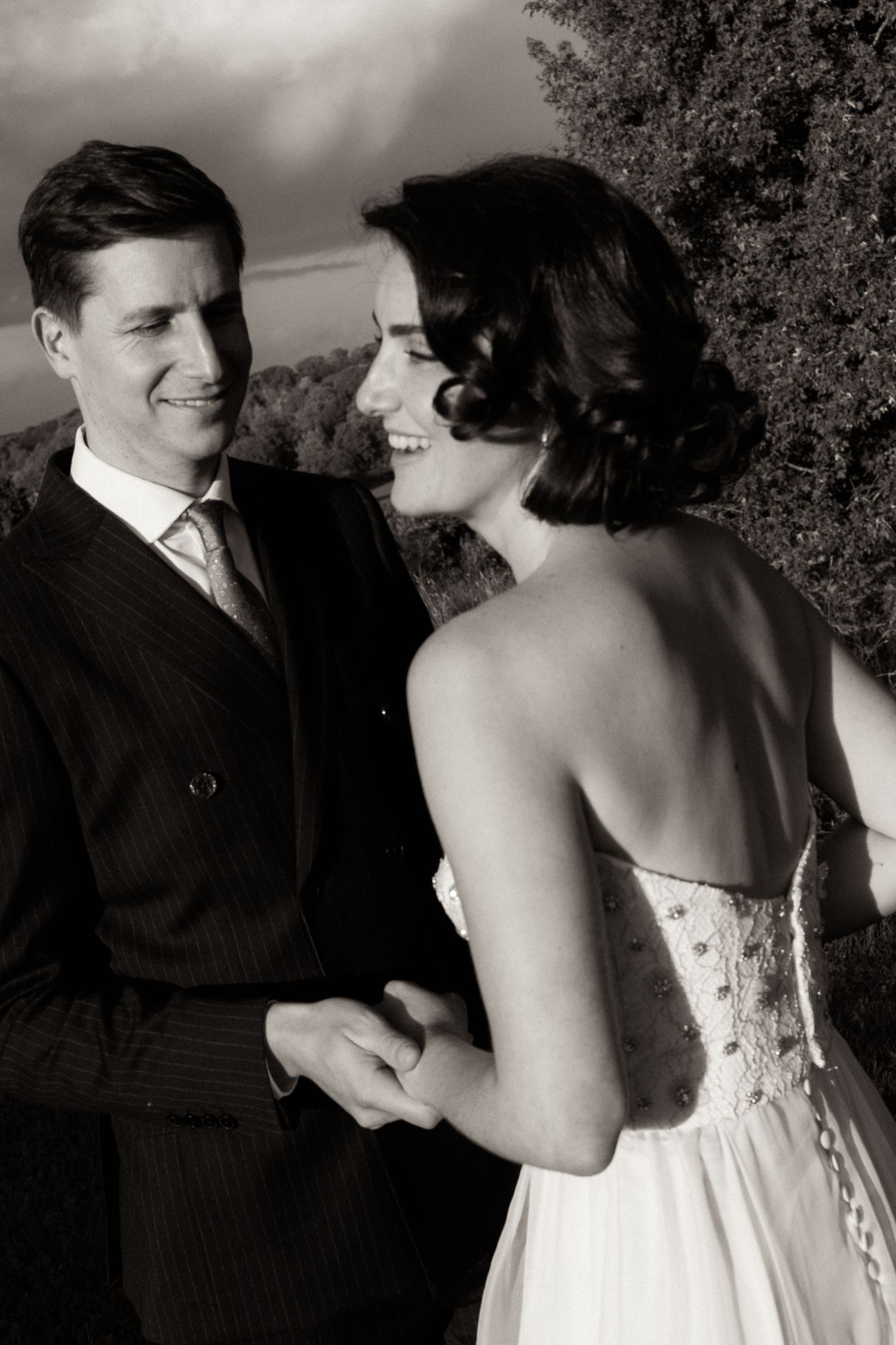 A romantic black and white photo sequence showing a couple in formal attire sharing intimate moments together.
