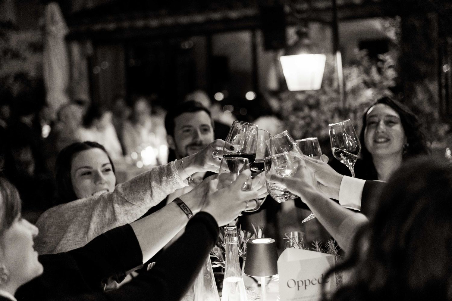 A black and white photo sequence shows joyful reactions and laughter during a candid social gathering.