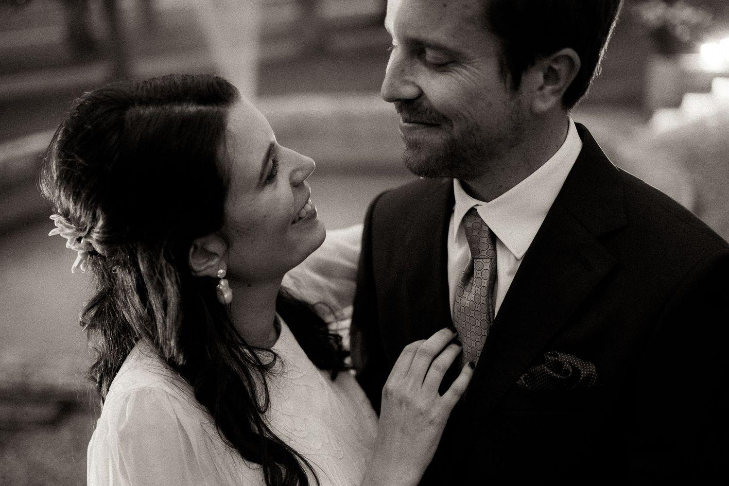 A romantic black and white photo series showing tender moments between a couple on their wedding day.
