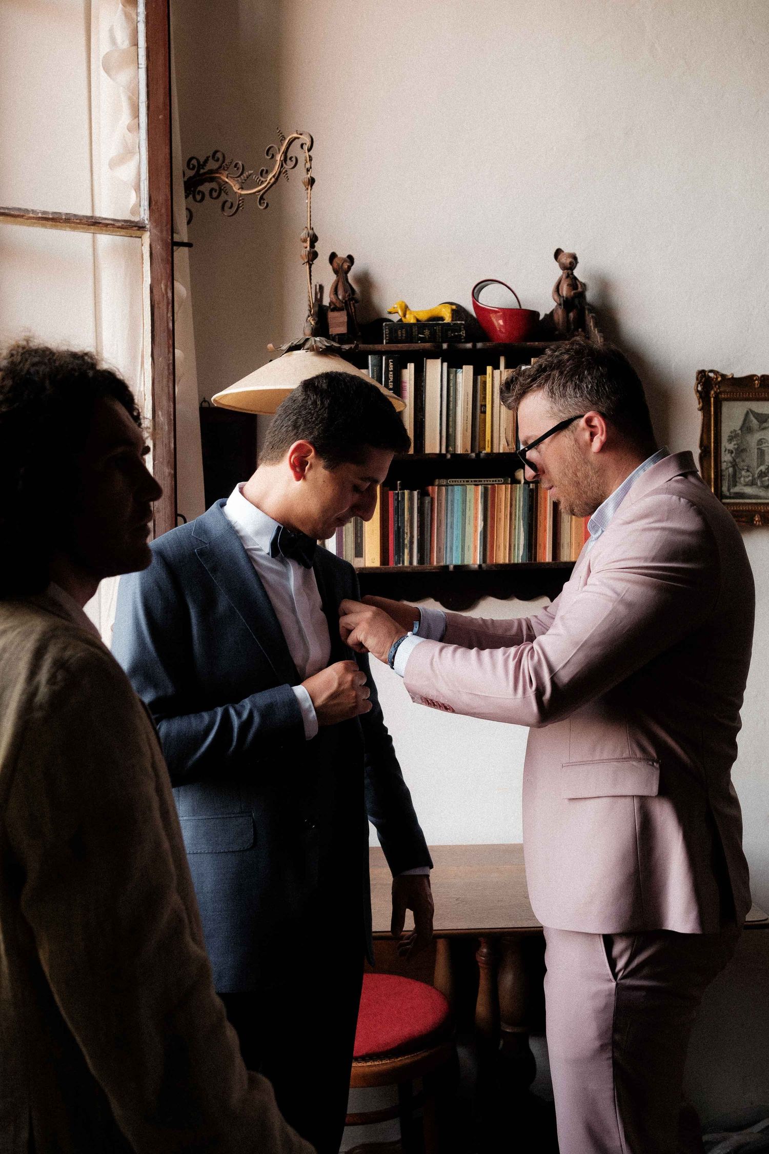 Two people in suits engage in a physical altercation sequence shown in multiple frames against an interior backdrop.