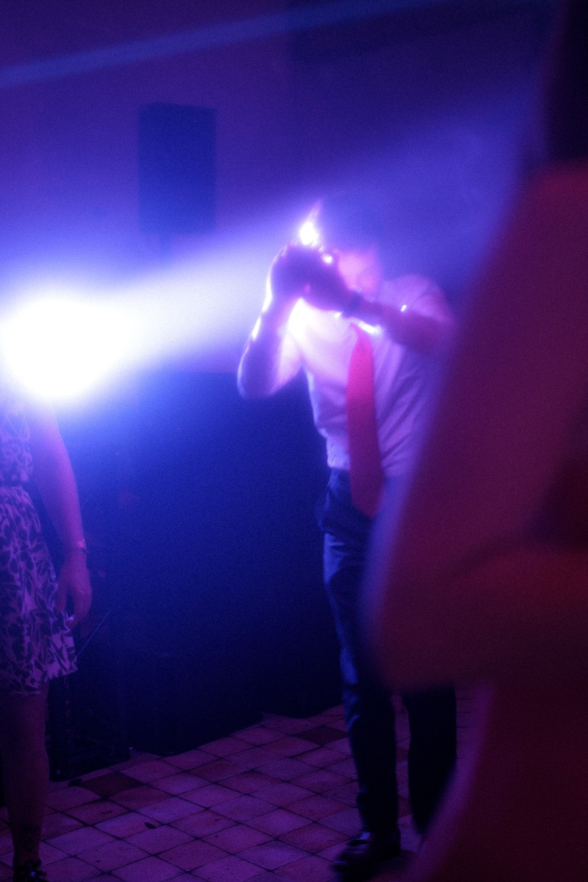 Person standing in a misty room with dramatic blue and purple lighting effects.