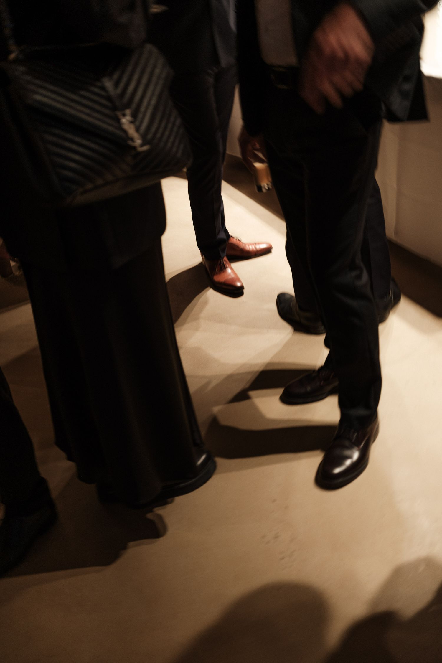 A sequence of photos showing black dress shoes and pant legs on a light-colored floor in dim lighting.