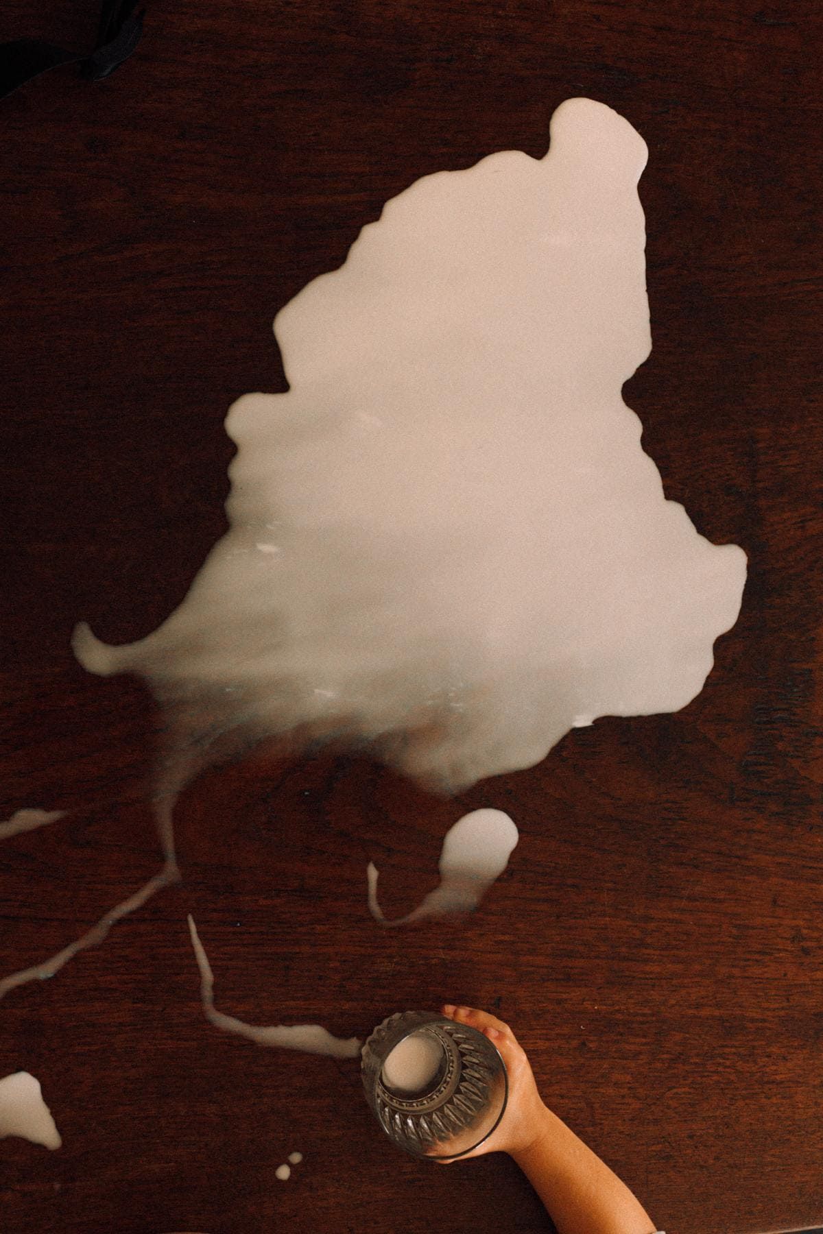 Smoke rings float gracefully through the air against a dark wooden background in a sequence of motion capture photos.