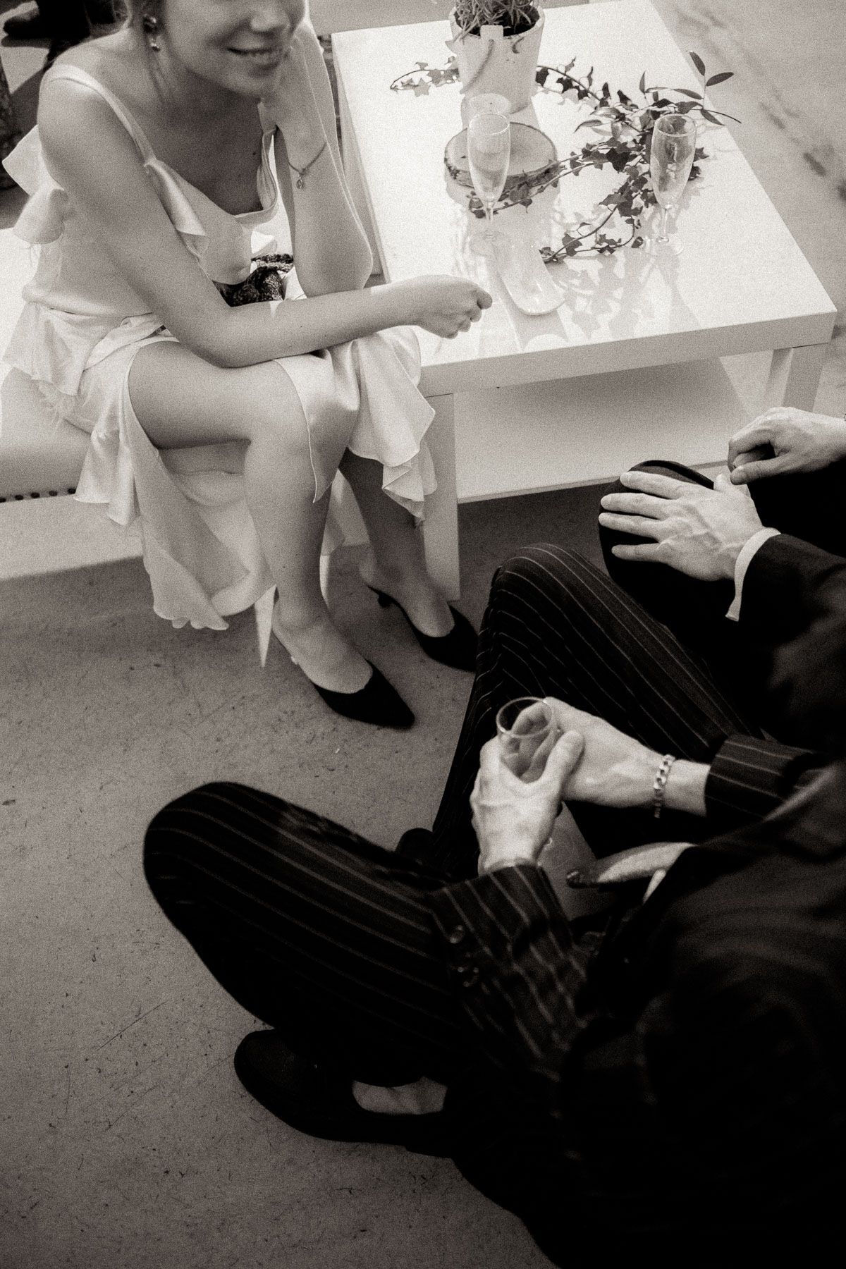 Black and white photo series showing couple signing documents at a table.