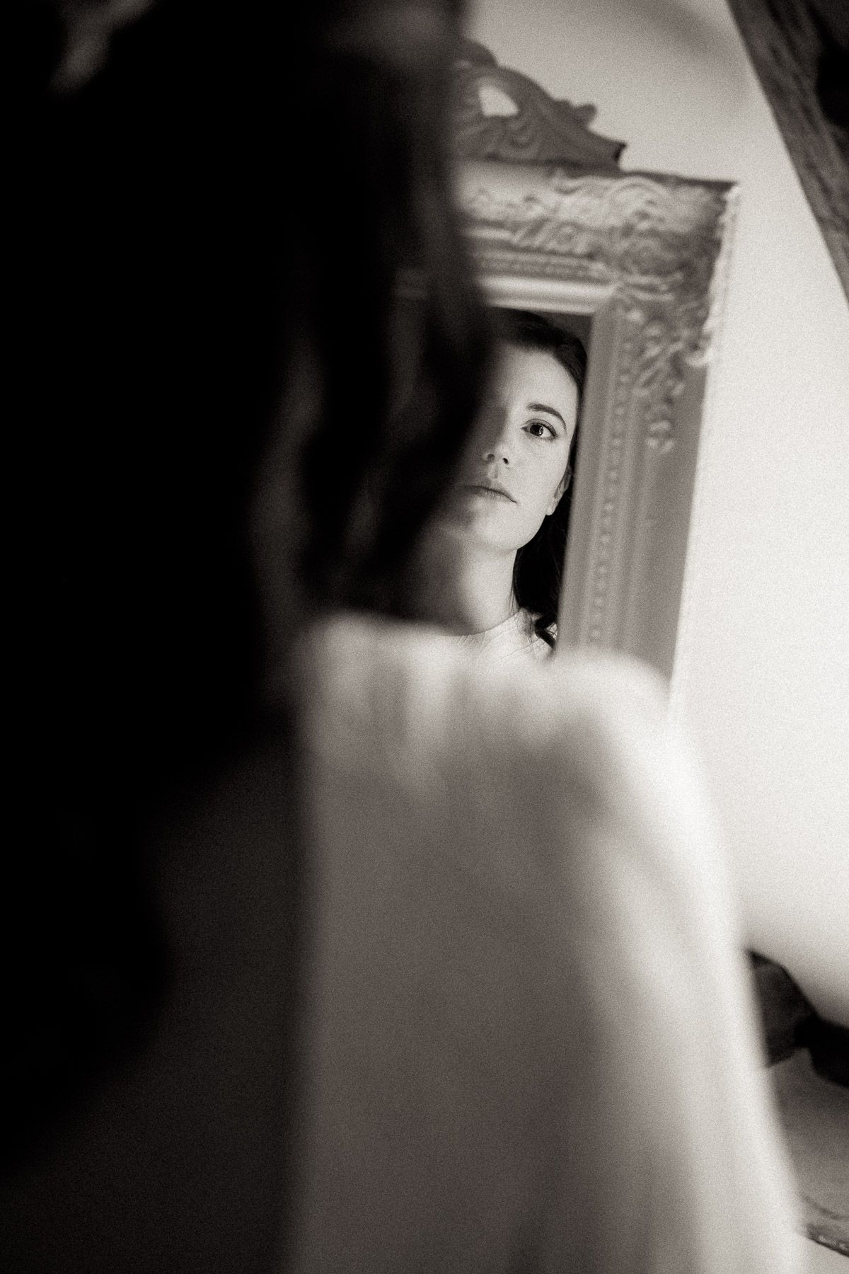 Artistic black and white portrait series showing fragments of a face in soft focus through multiple frames.