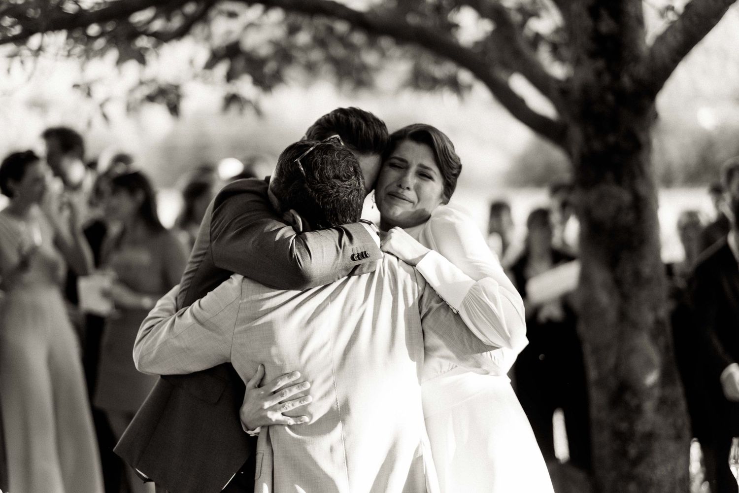 A series of black and white wedding photos showing couples dancing and embracing at a celebration.