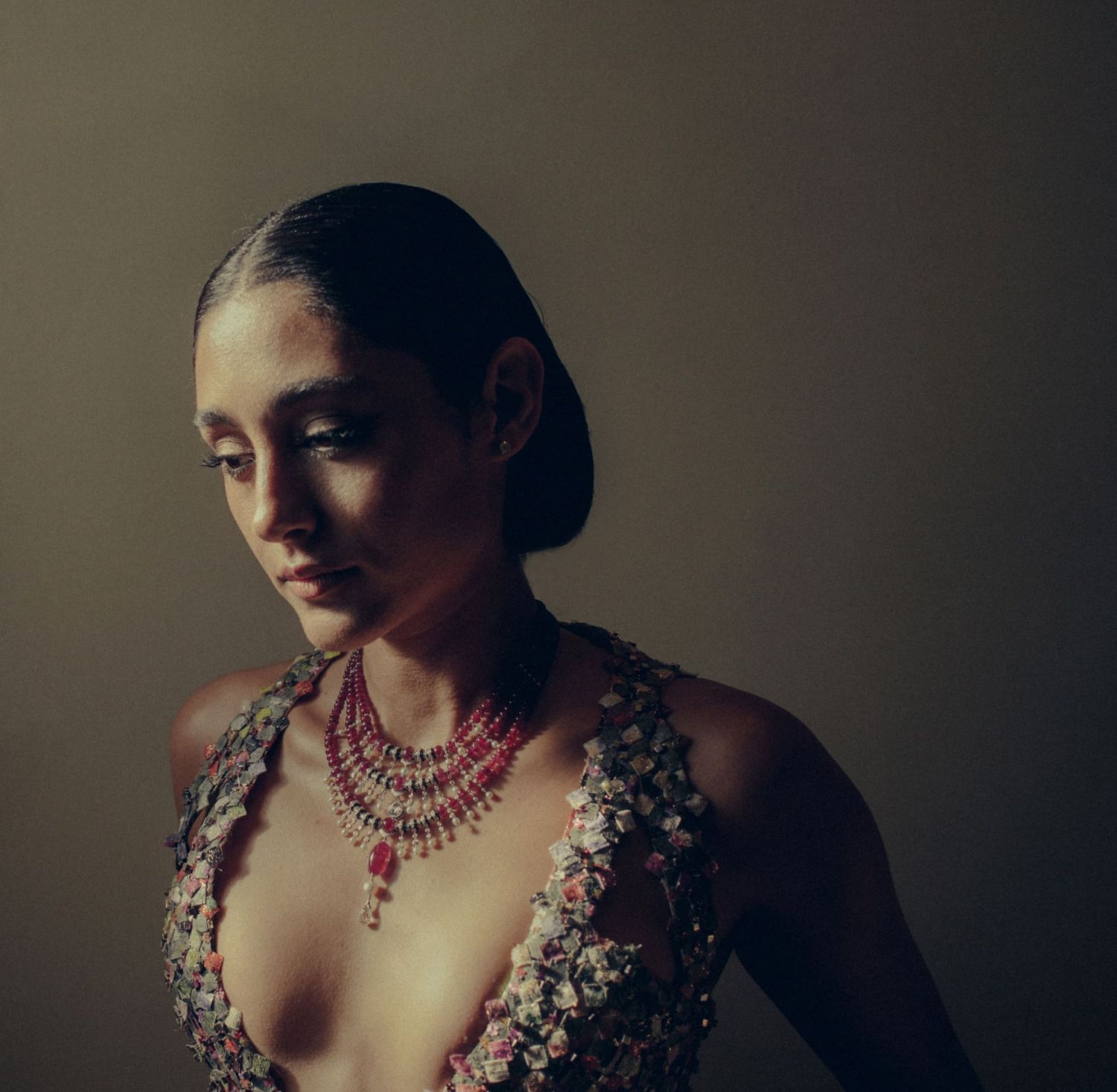 Dramatic portrait series showing a figure adorned with ornate jewelry in moody lighting and vintage-inspired styling.