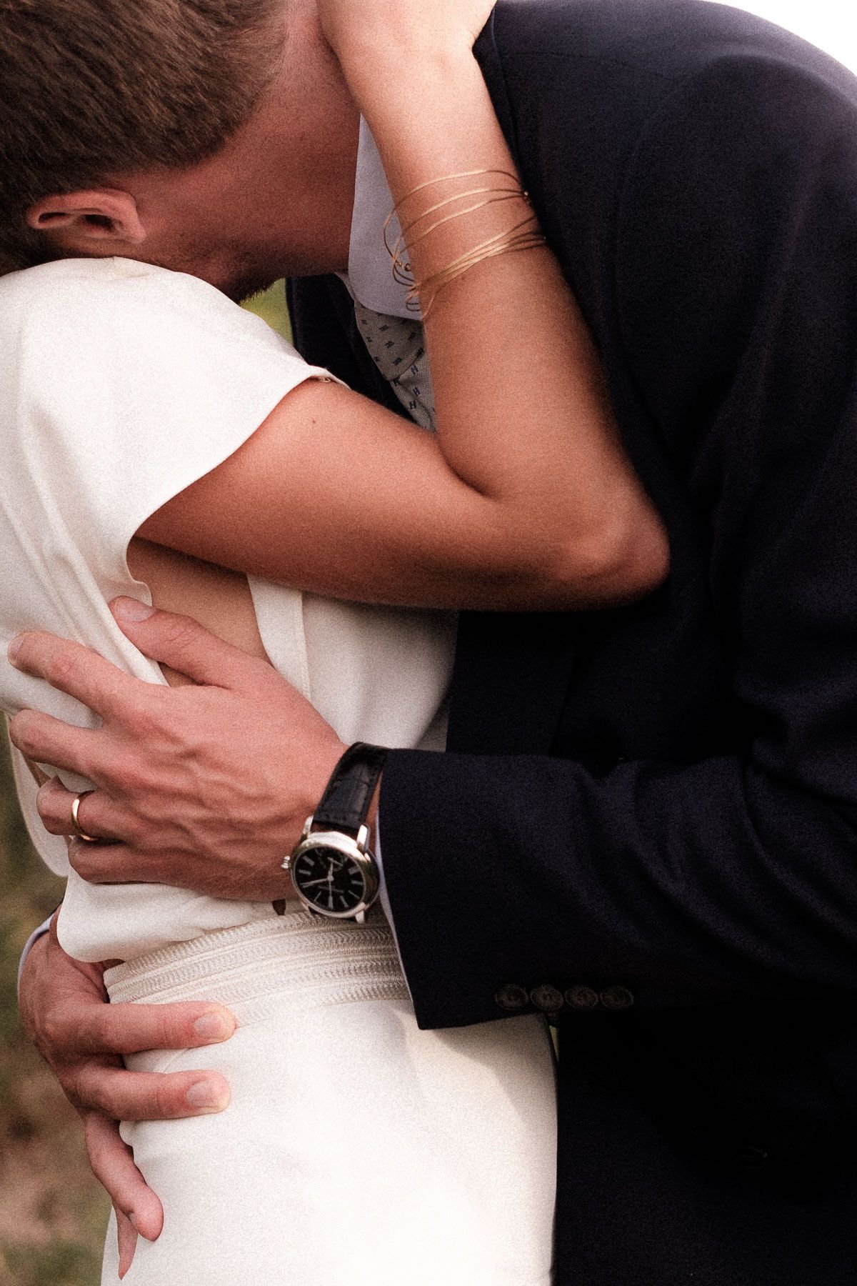 Close-up series of romantic embraces showing a couple in formal wedding attire against a dark background.