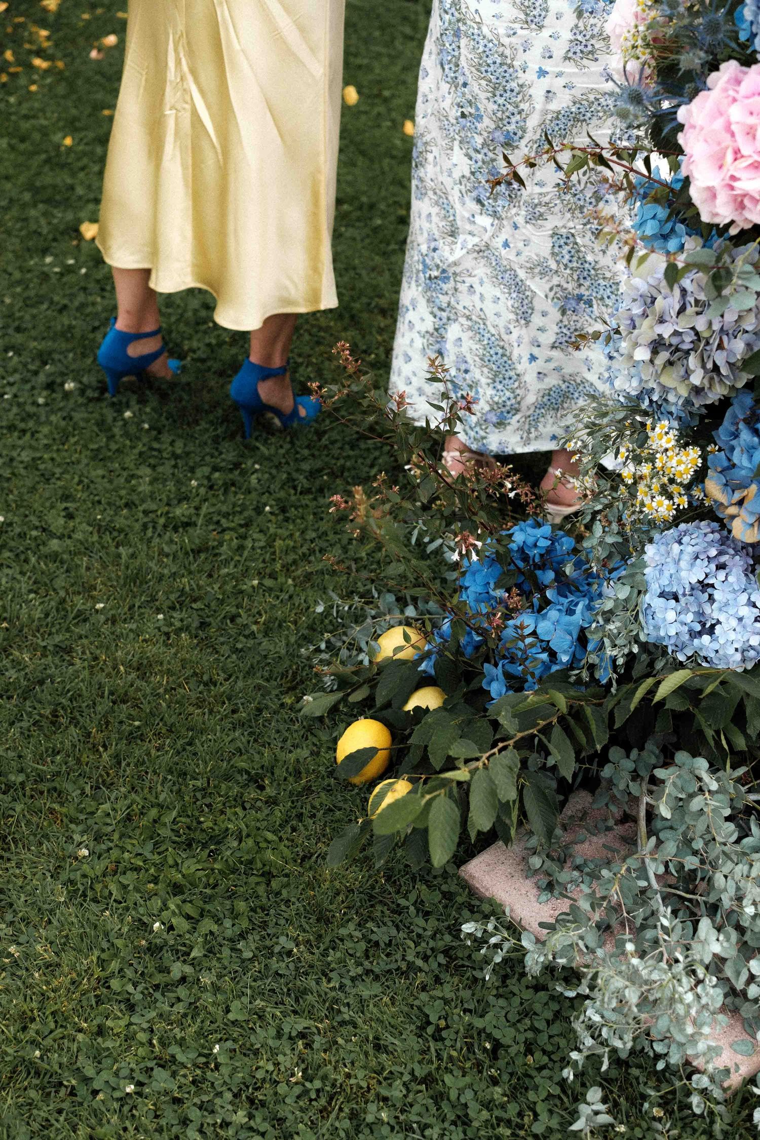 A sequence of images showing yellow shoes and floral dresses against green grass with blue and white flowers.
