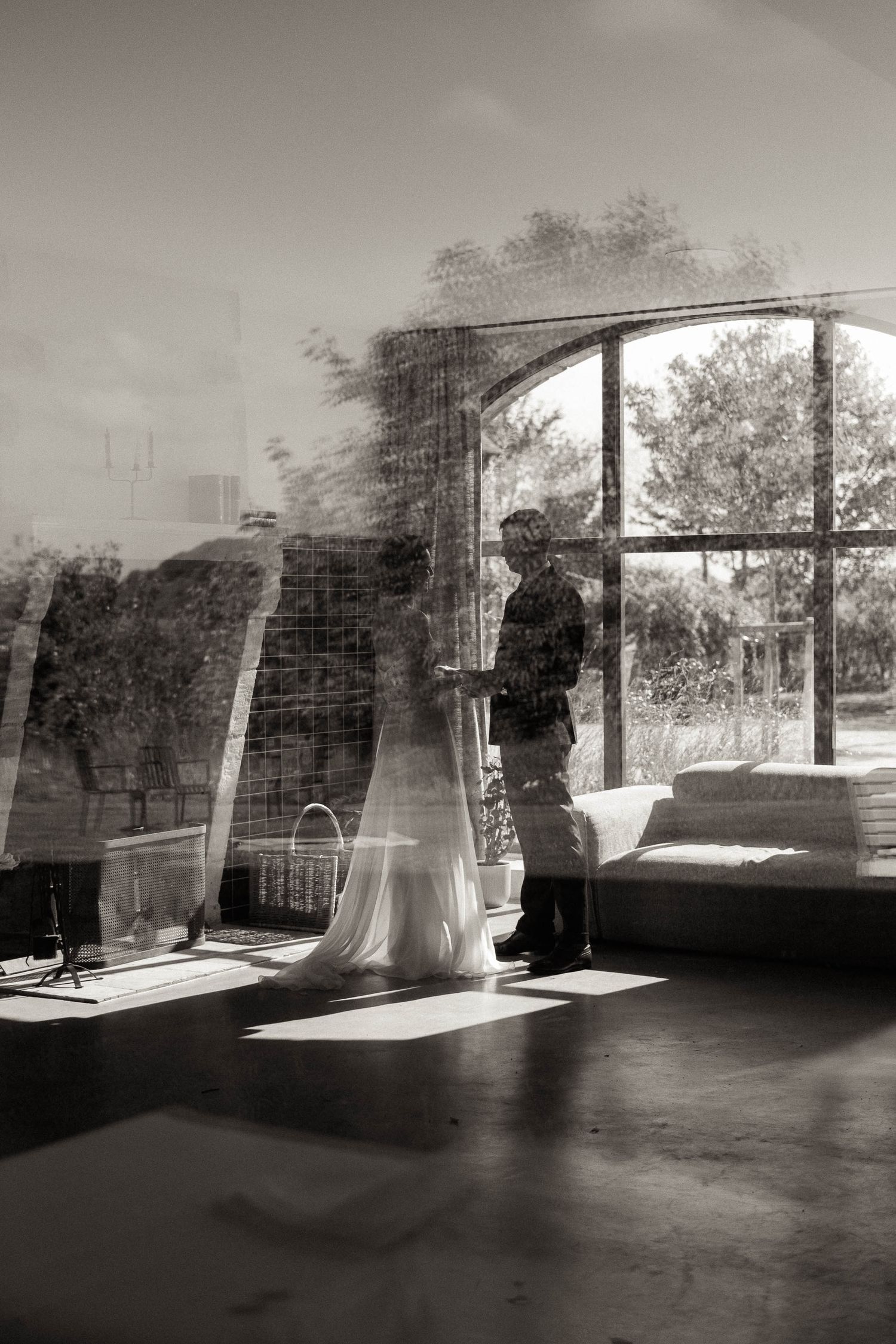 A sequence of black and white photographs showing sunlight streaming through arched windows in an empty room.