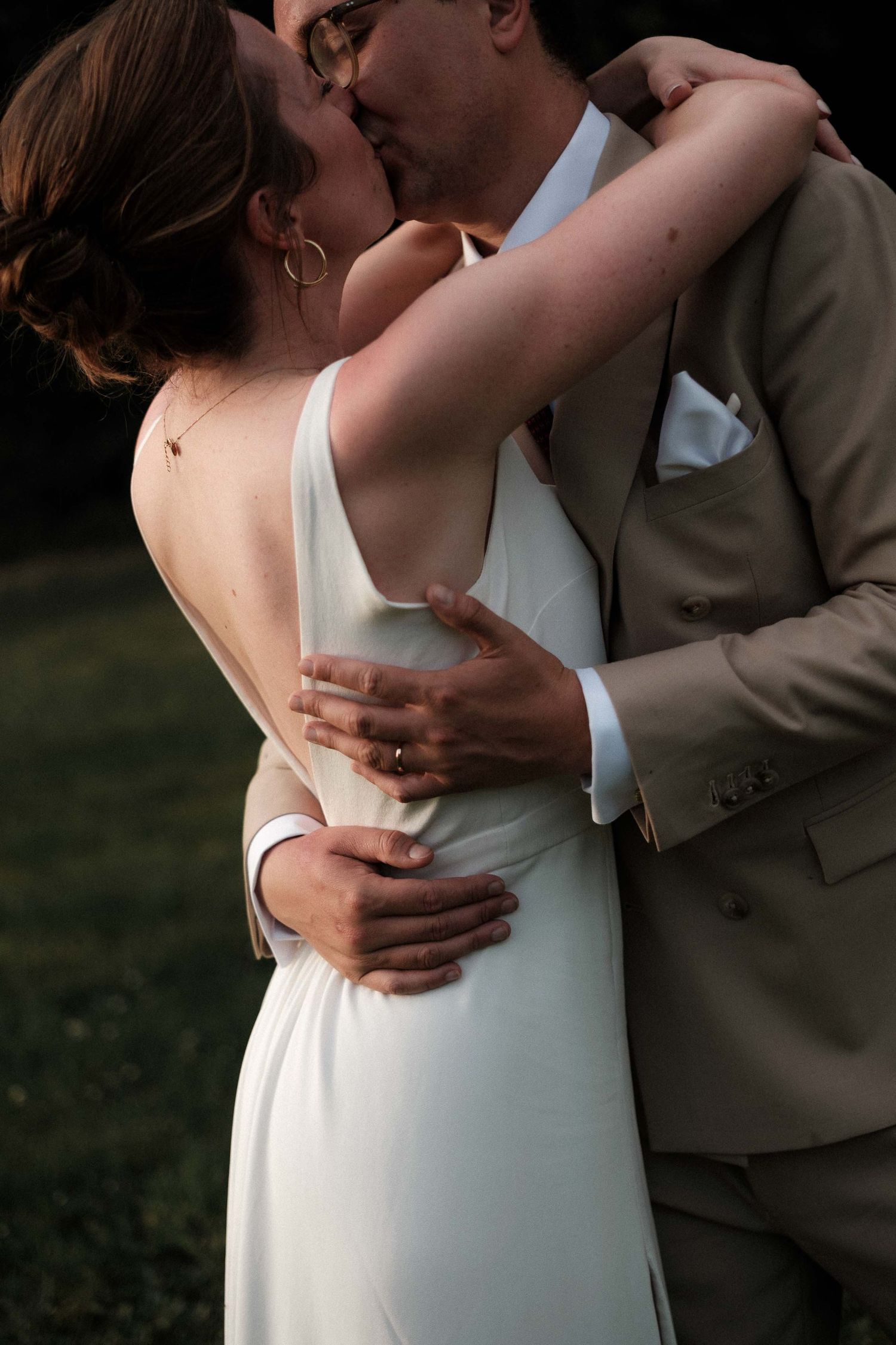 A romantic moment captured in a series of intimate wedding photos showing a couple embracing in white and tan attire.