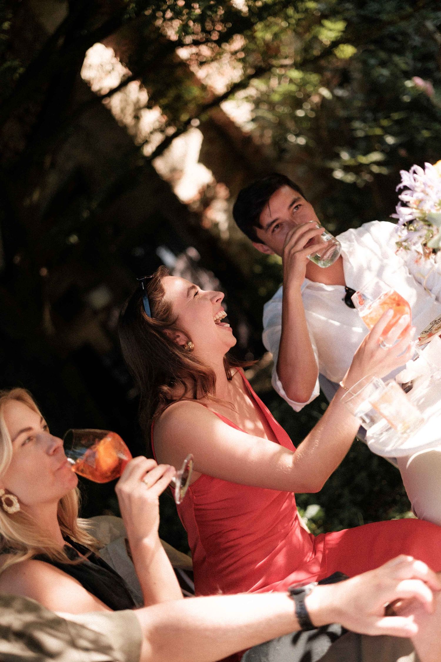 A sequence of photos showing someone drinking from a bottle in an exaggerated manner outdoors.