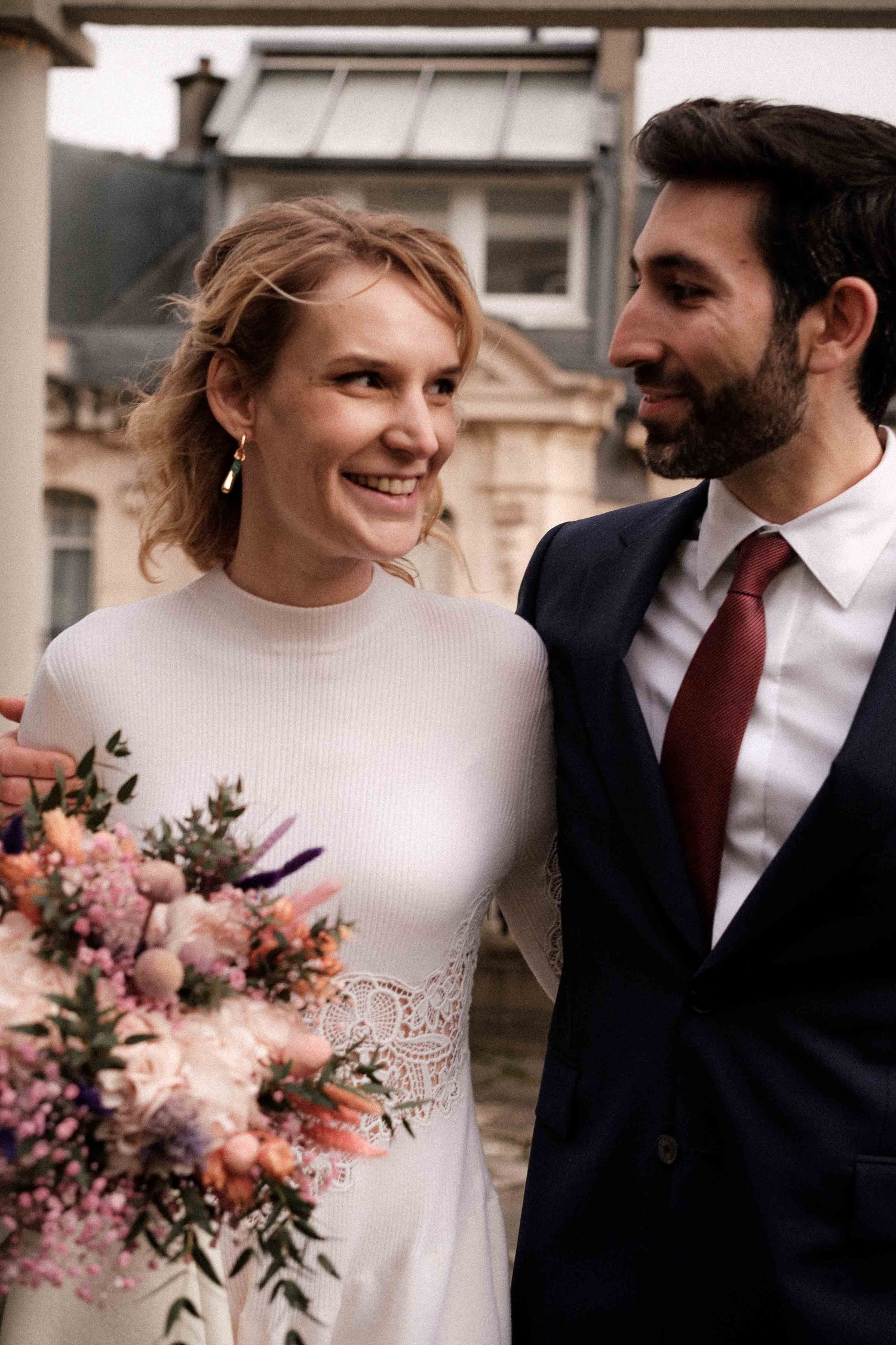 Romantic wedding couple shares intimate moments in a series of candid photographs with pink floral bouquet details.