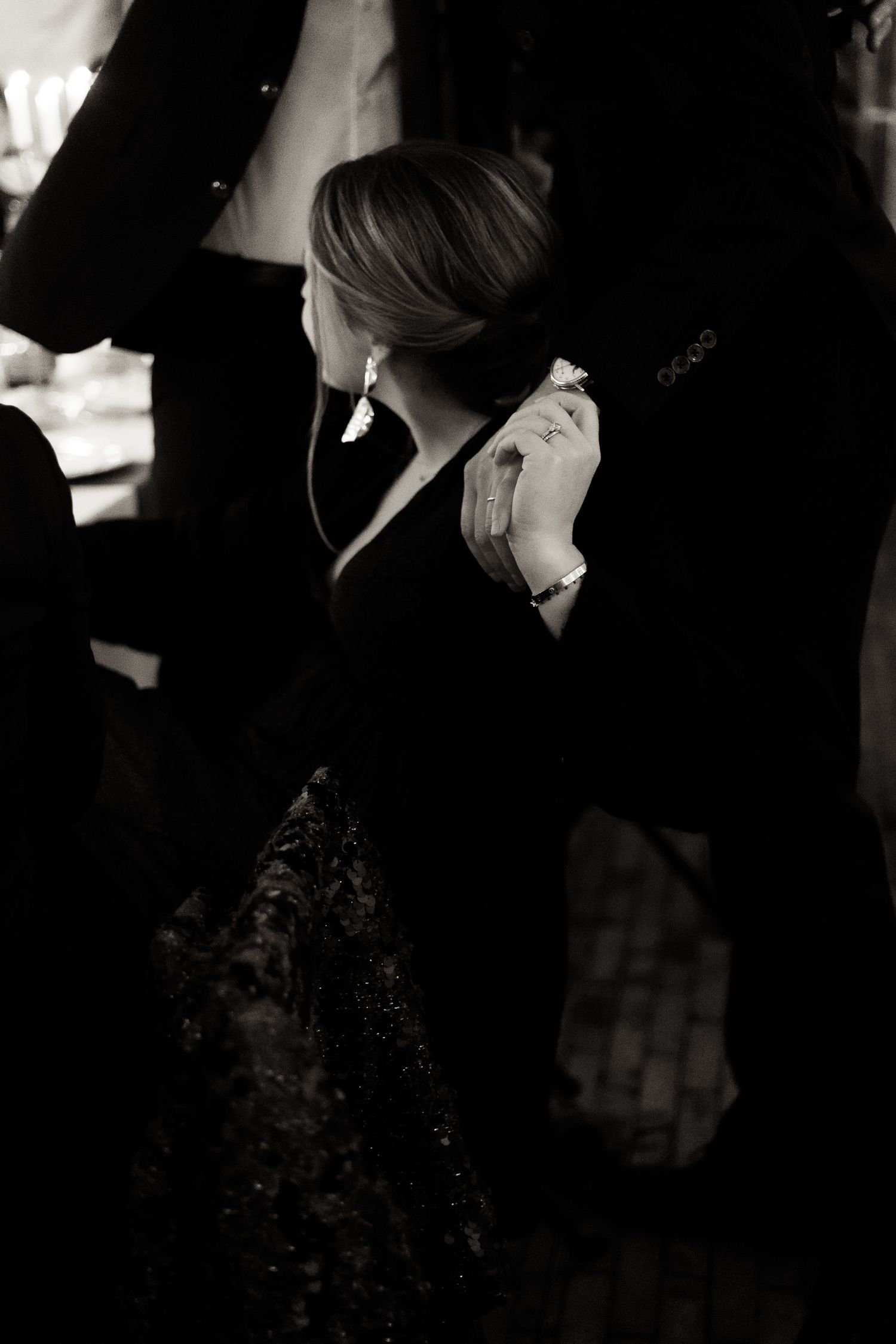 A black and white photo series showing silhouettes of people in conversation against a dark background.