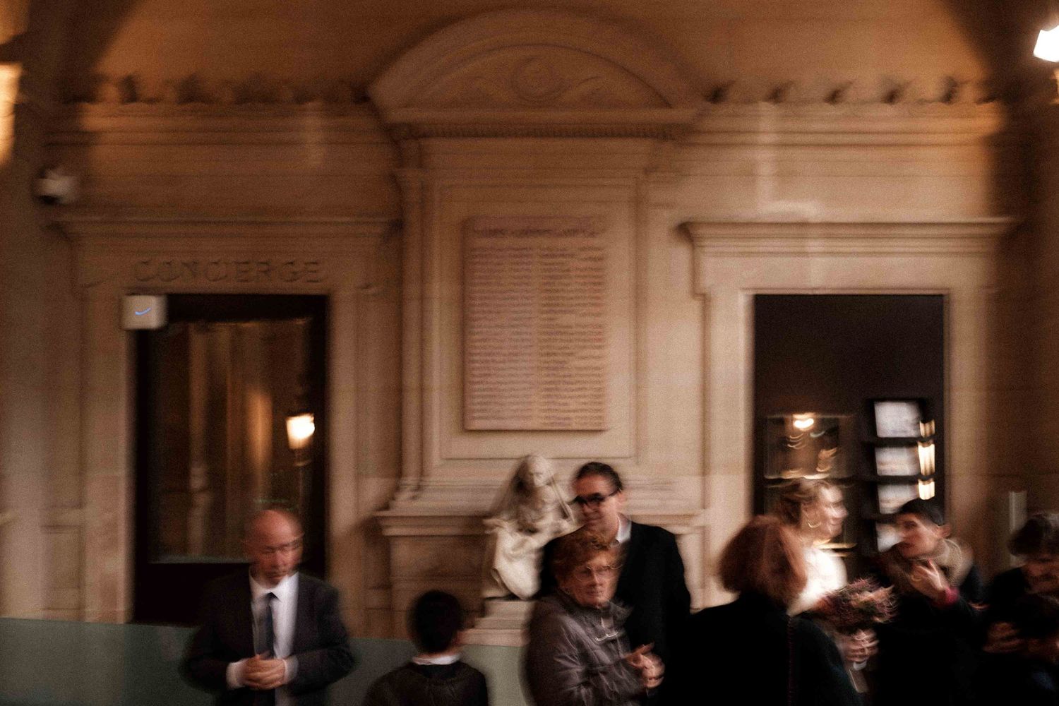A formal wedding ceremony takes place in an elegant church with ornate architecture and soft lighting.