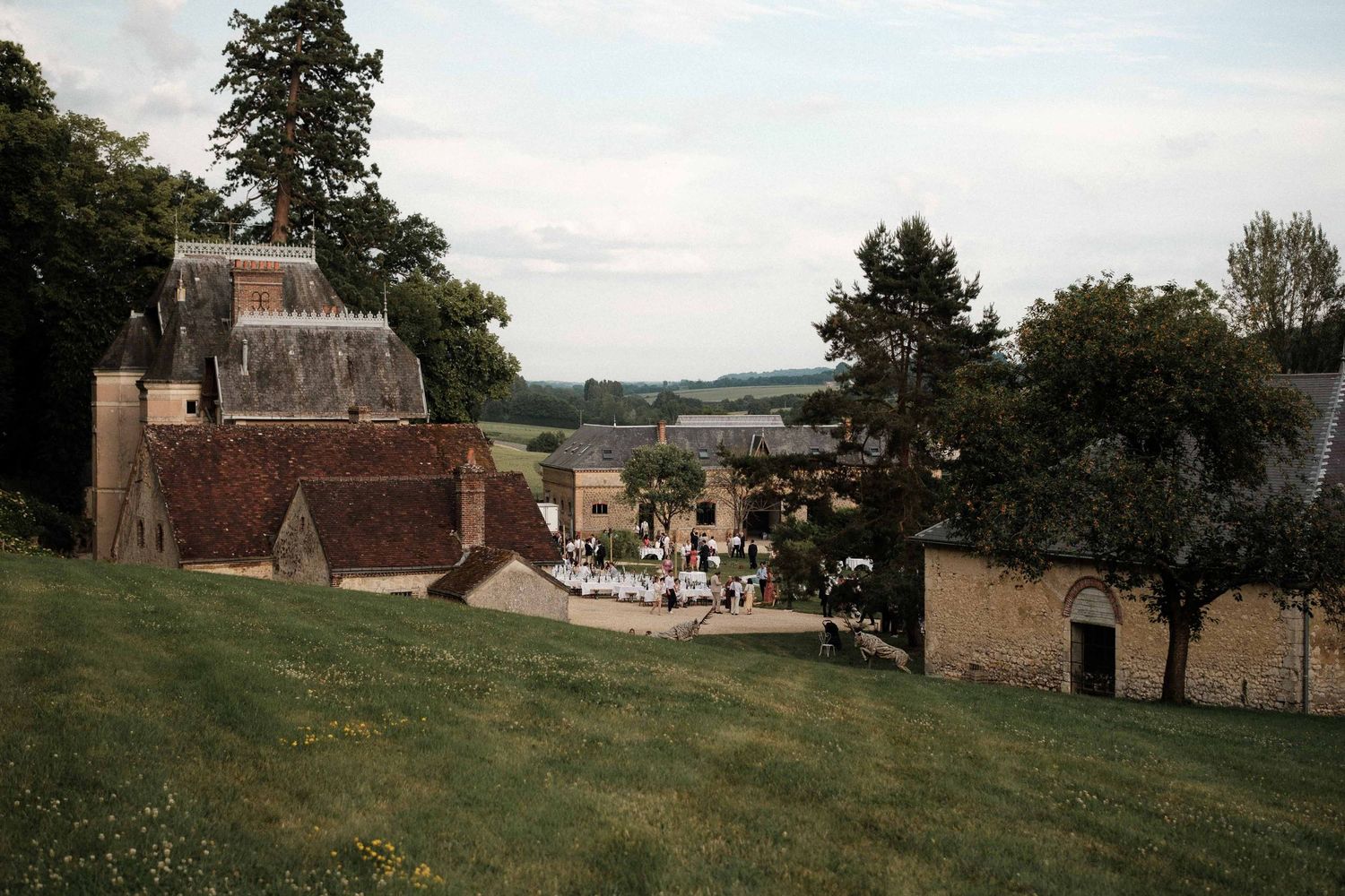 A series of seven connected panoramic landscape photos showing rural farm buildings and rolling countryside views.