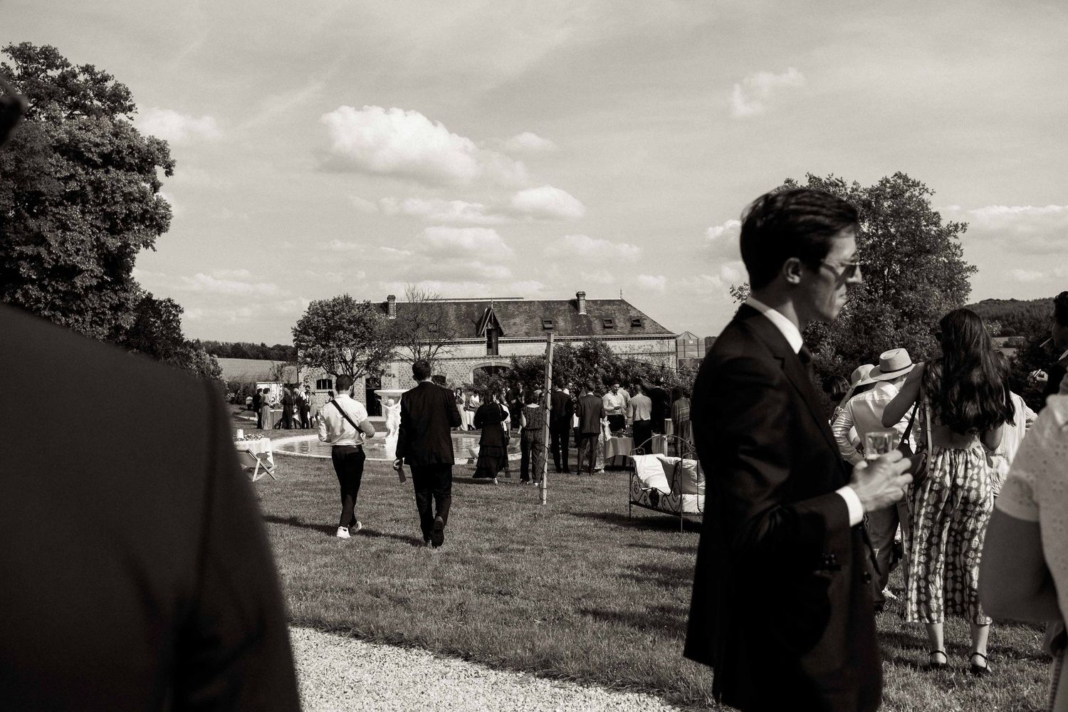 Black and white photo montage showing candid moments from an outdoor wedding ceremony and reception.