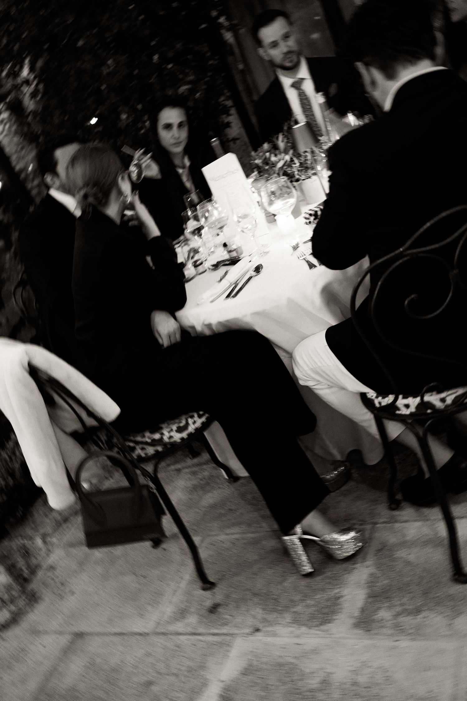 Black and white photo sequence showing dancers' feet and legs moving across a dance floor at a formal event.