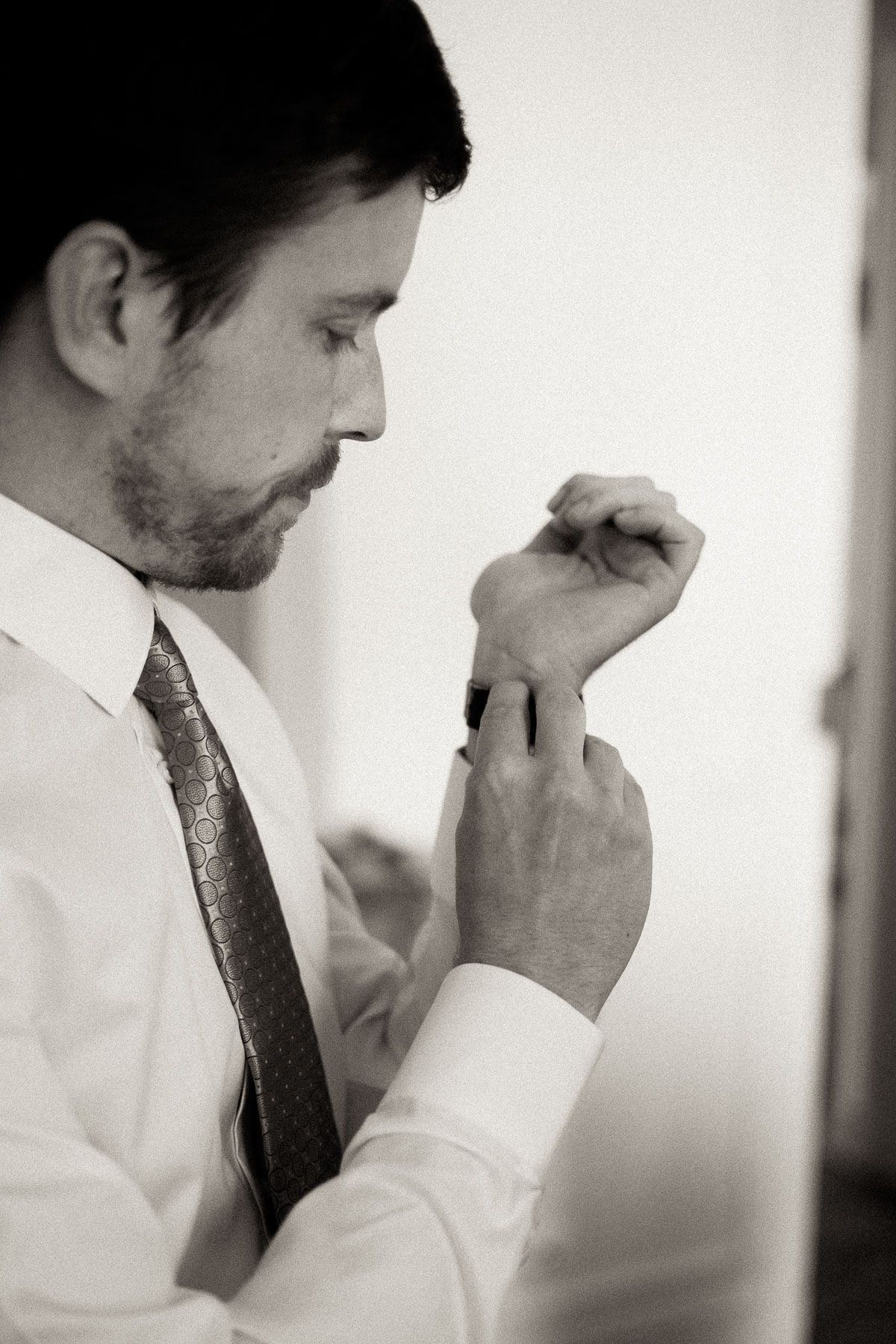 A series of black and white photos showing a person in business attire touching their face thoughtfully.