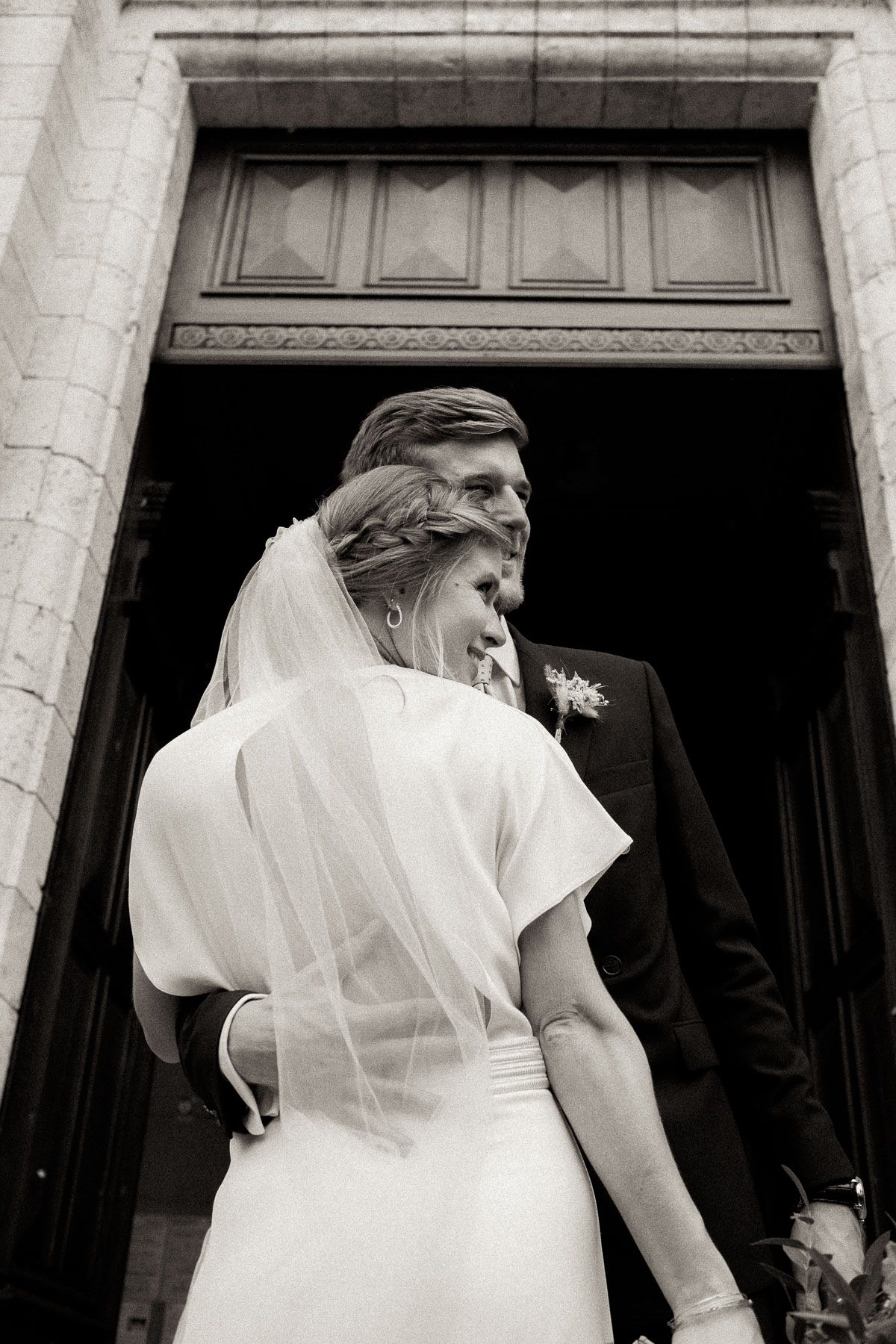 A bride in a white wedding dress and veil shown in a series of black and white photographs.