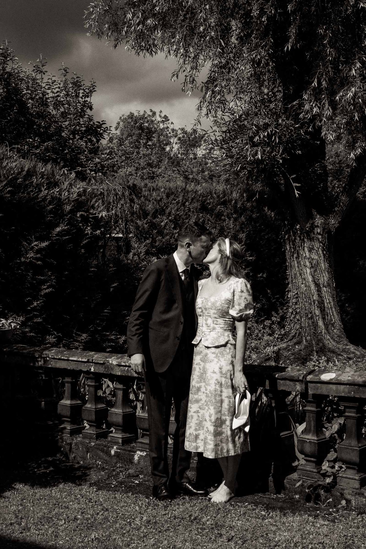 A series of vintage black and white photographs showing a couple walking and posing together in a park setting.