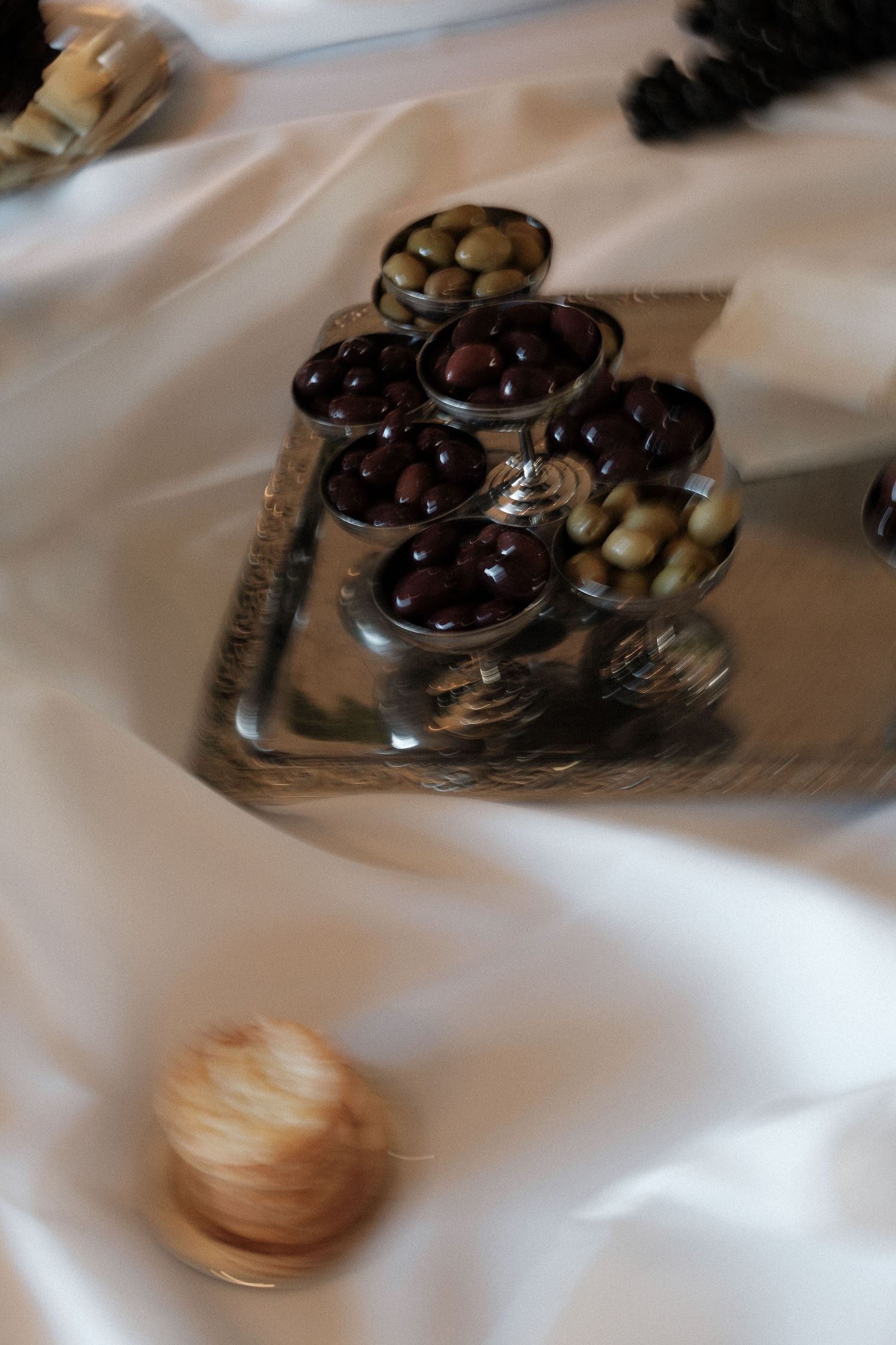 Blurry motion sequence showing chocolate truffles and macarons on a white surface.