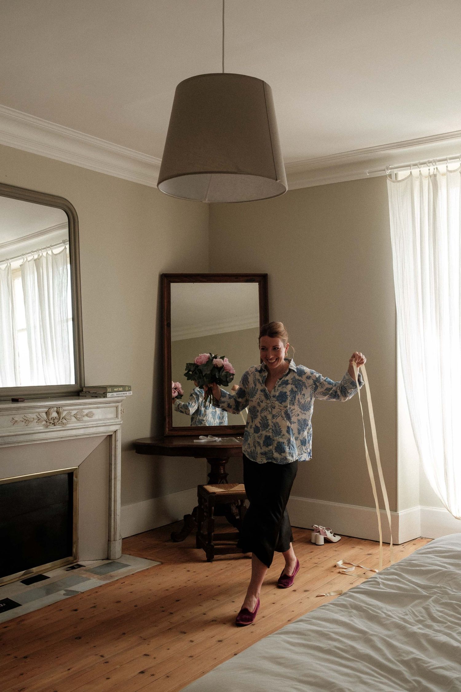 A sequence of photos showing someone dancing energetically across a sunlit room with hardwood floors and white curtains.