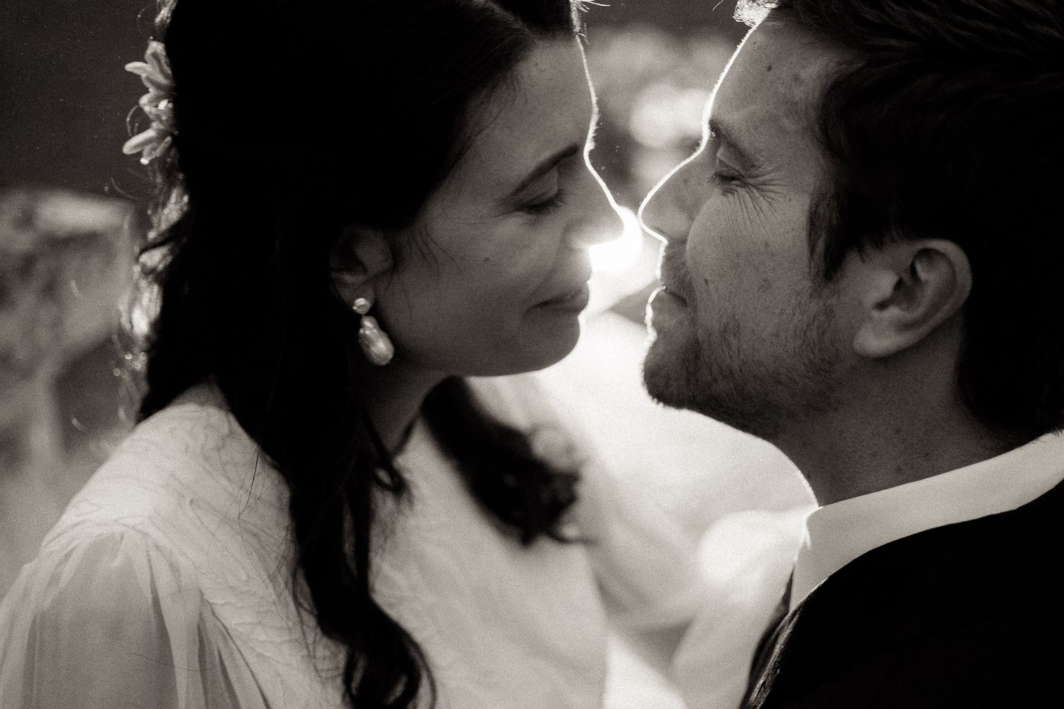 Five black and white romantic photos showing intimate close-up moments between couples about to kiss.