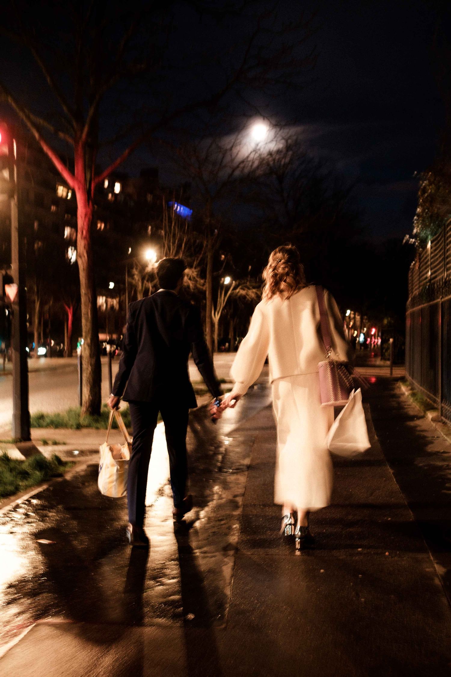 A series of ghostly figures illuminated at night along a path create an eerie Halloween atmosphere.