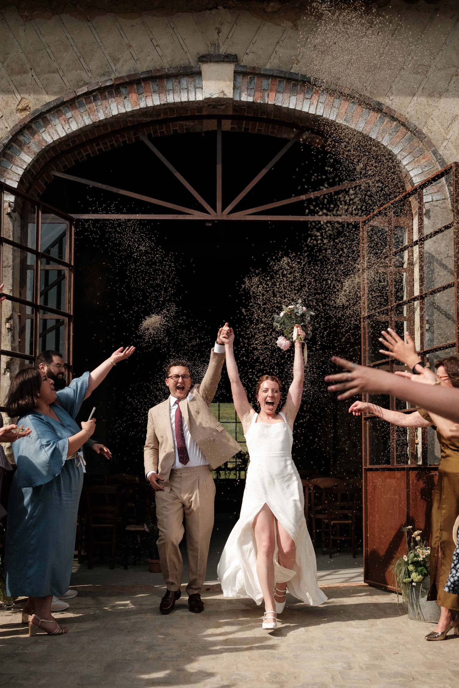 Wedding guests celebrate by throwing rice at the newlyweds as they exit the rustic venue in a joyful sequence of photos.