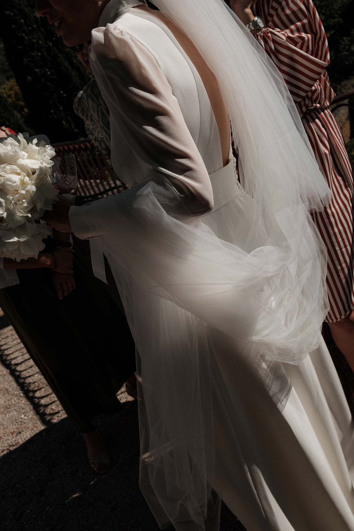 A series of romantic wedding photos showing the flowing movement of a white bridal gown against a striped background.