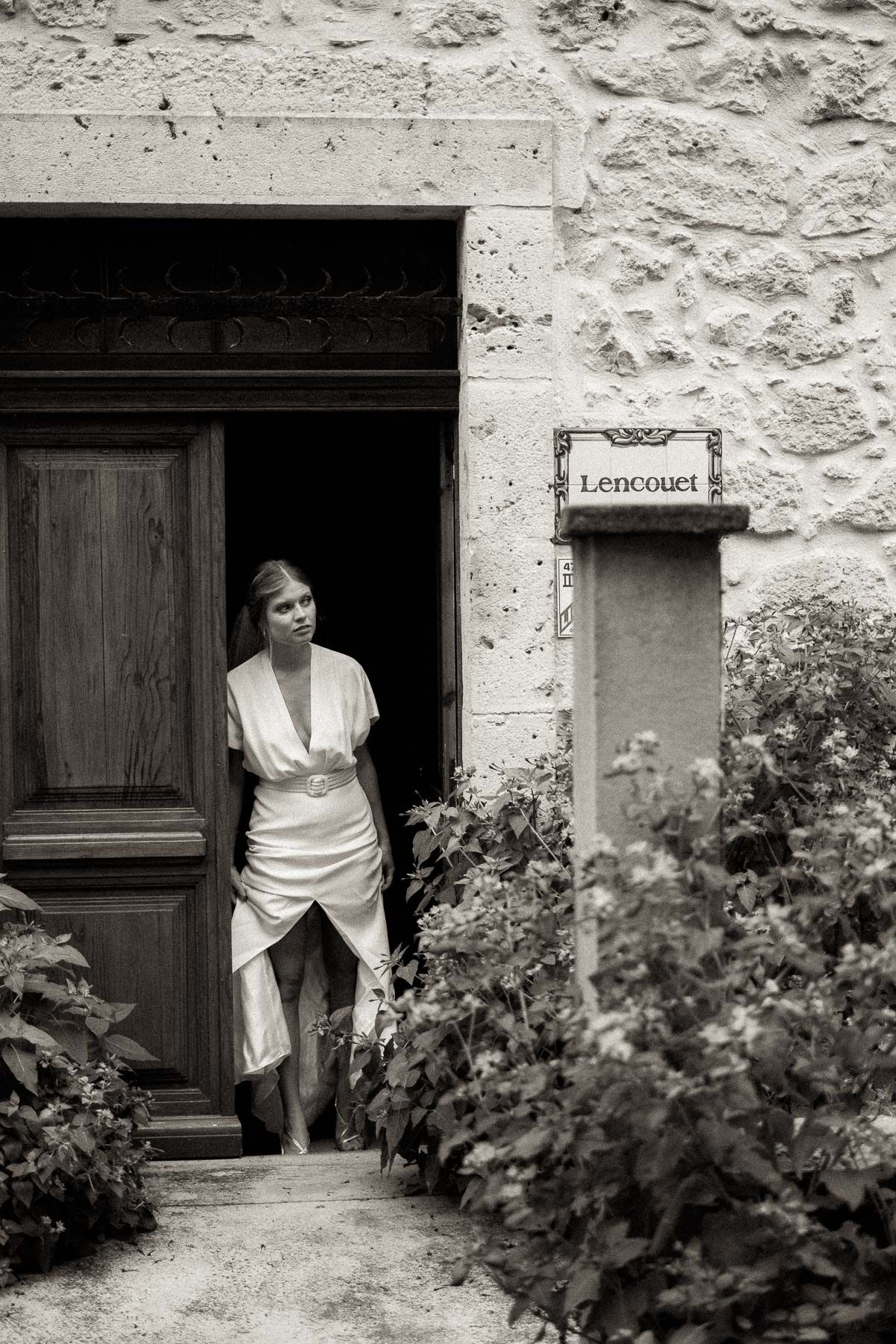 A series of black and white photographs showing doorways and entrances to a rustic stone building with vines growing.