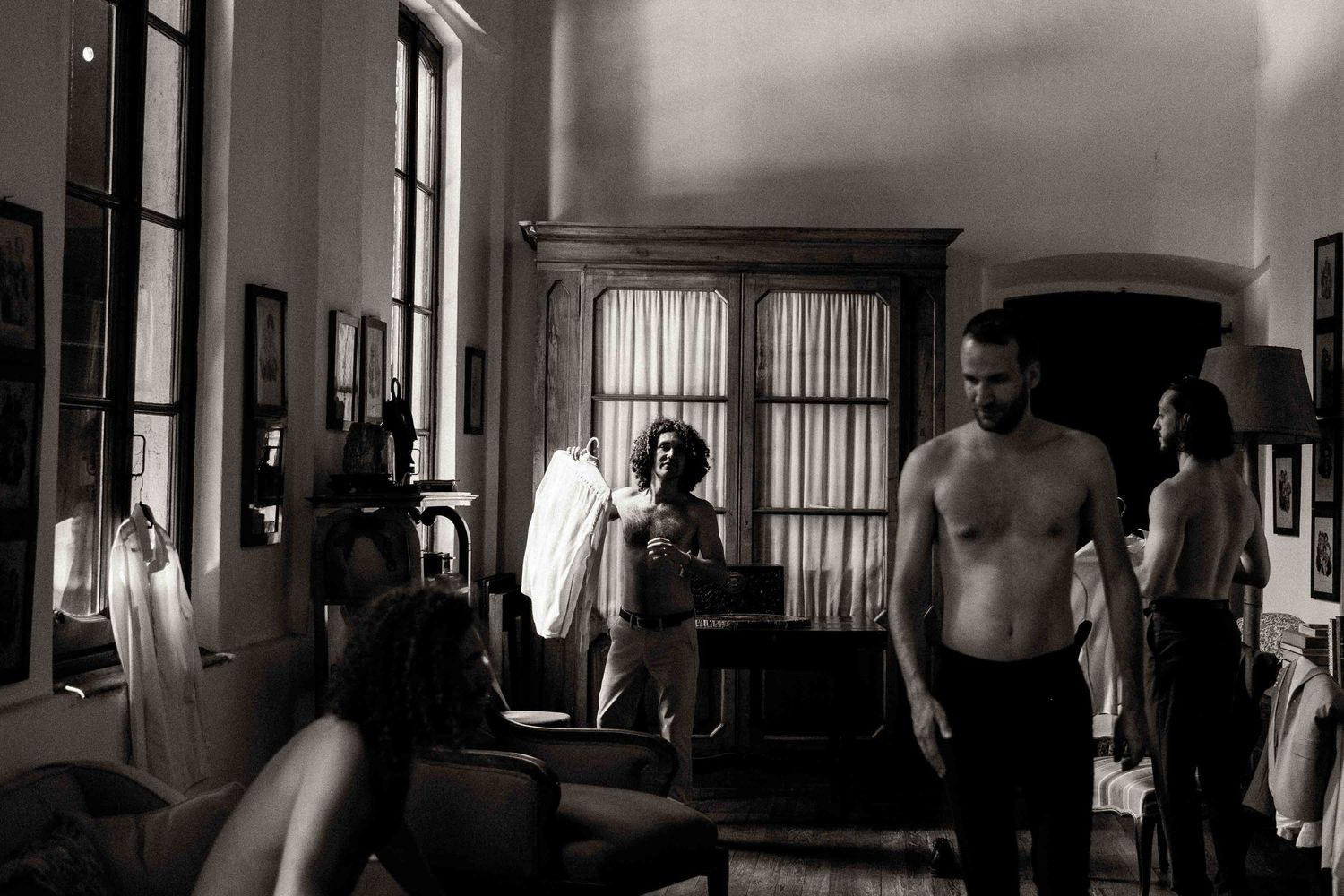 Vintage black and white photograph showing inmates inside a prison corridor with barred cells and guards.