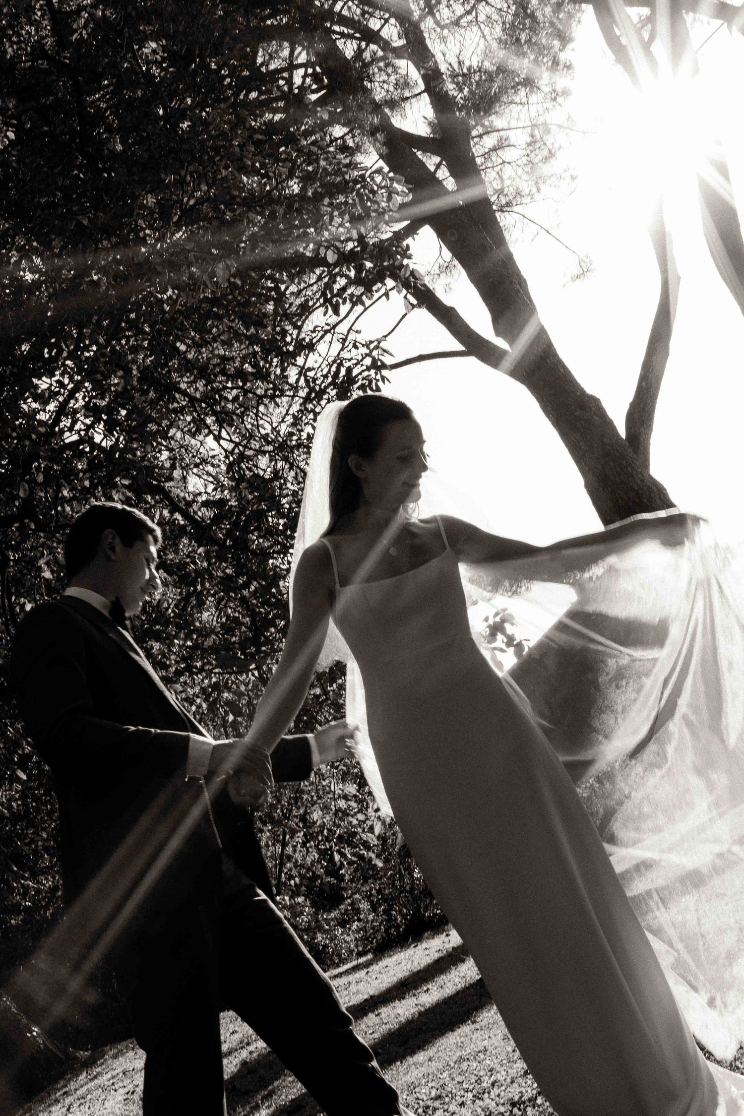 A series of artistic black and white wedding photos showing a couple dancing in sunlit garden setting.