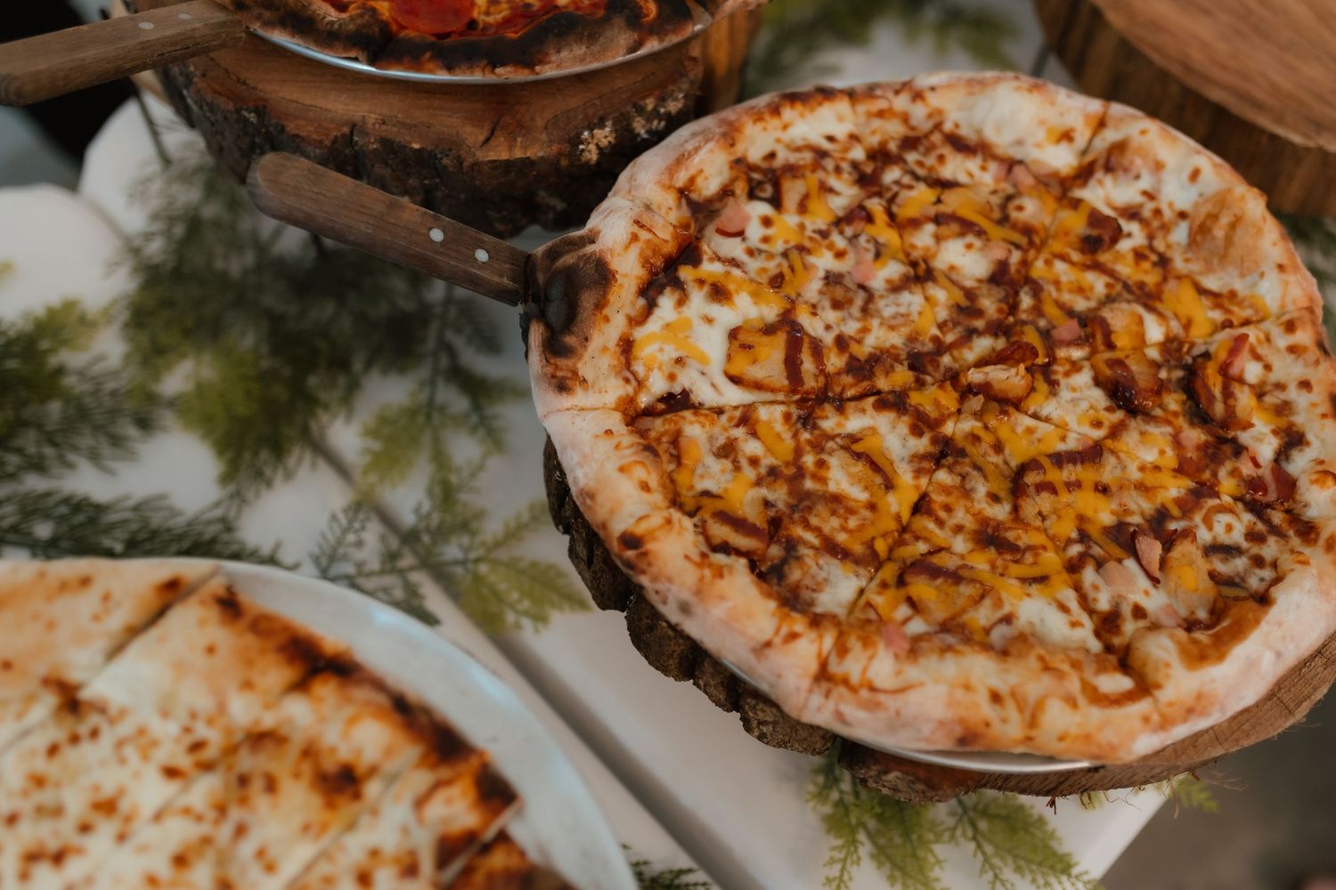 Delicious BBQ chicken pizza displayed at wedding reception food station.