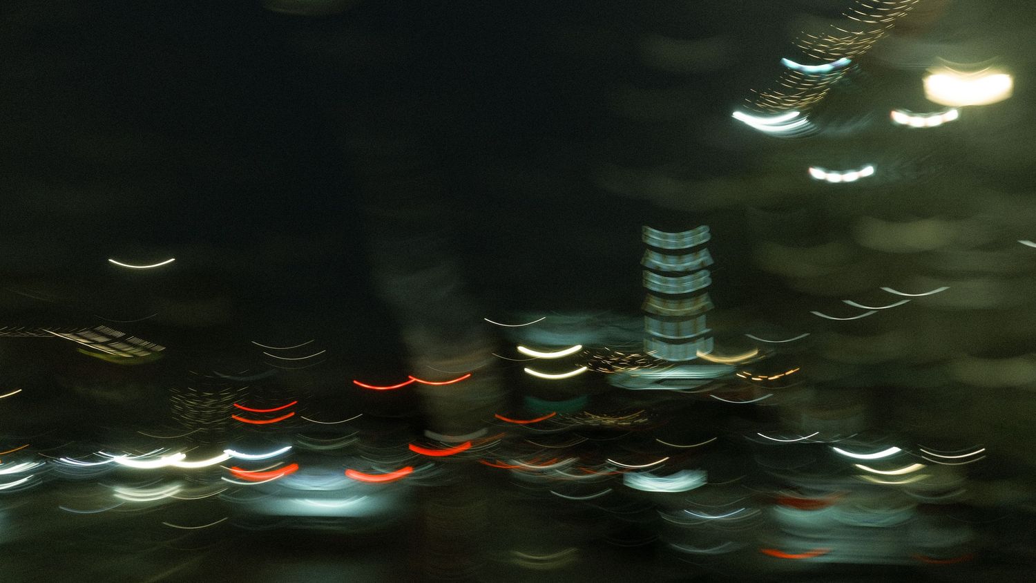 Abstract long exposure night photography showing colorful light trails in city.
