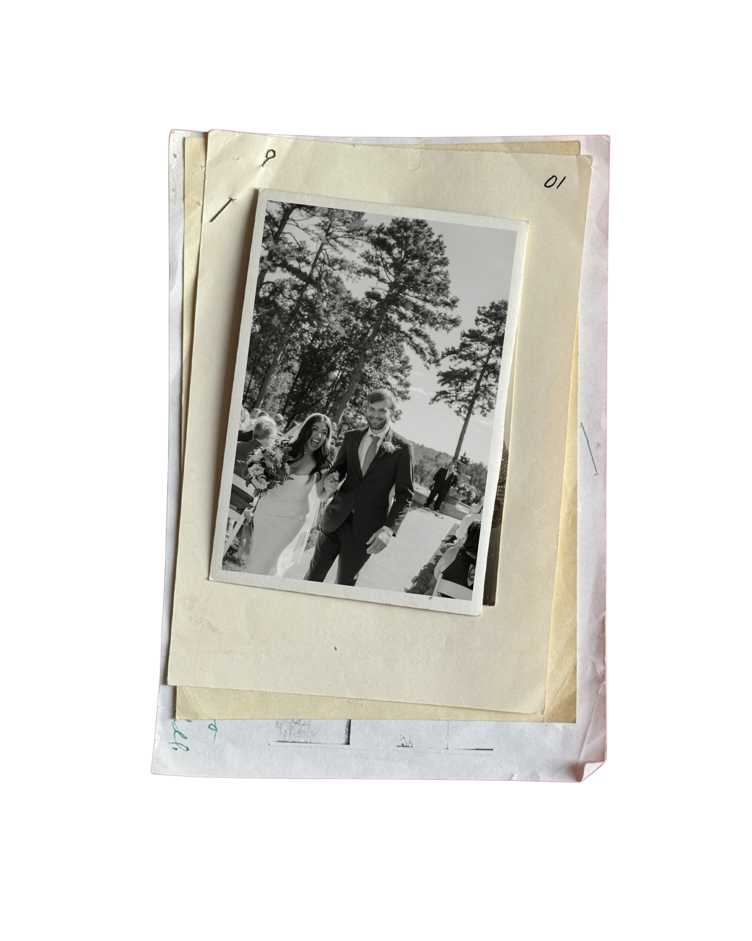 Vintage black and white wedding photo of couple walking outdoors stacked on old papers.
