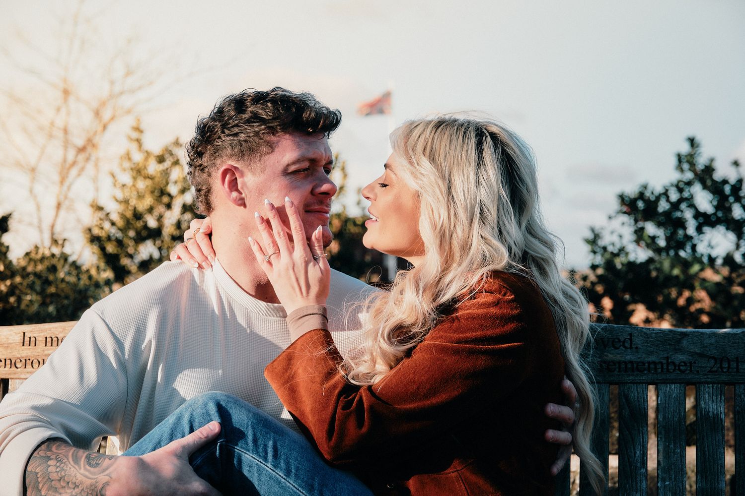 Romantic sunset portraits captured on a stone bridge with warm lighting.