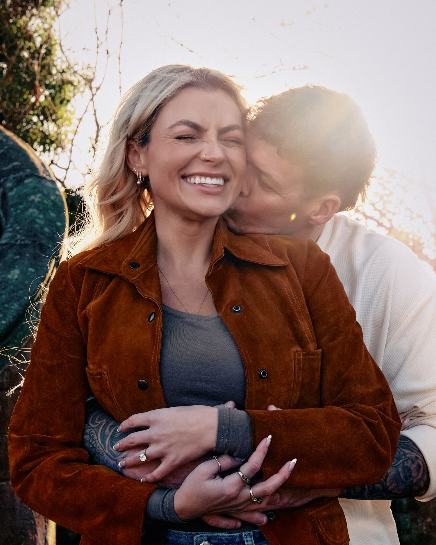 Couple sharing intimate moments in a series of candid photos at sunset wearing brown suede jacket and white sweater.